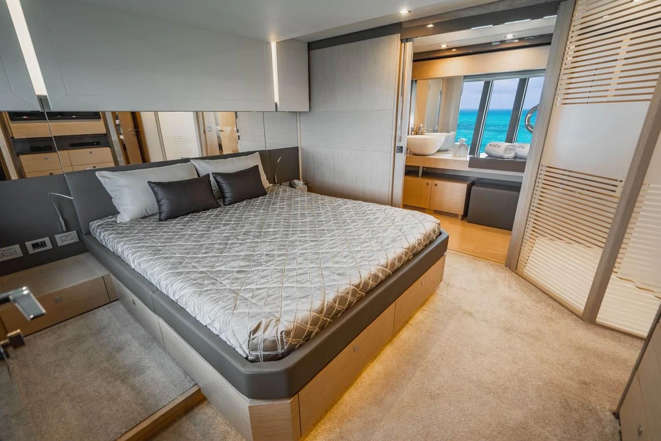 a bedroom with a bed and a window aboard KUDU Yacht for Sale