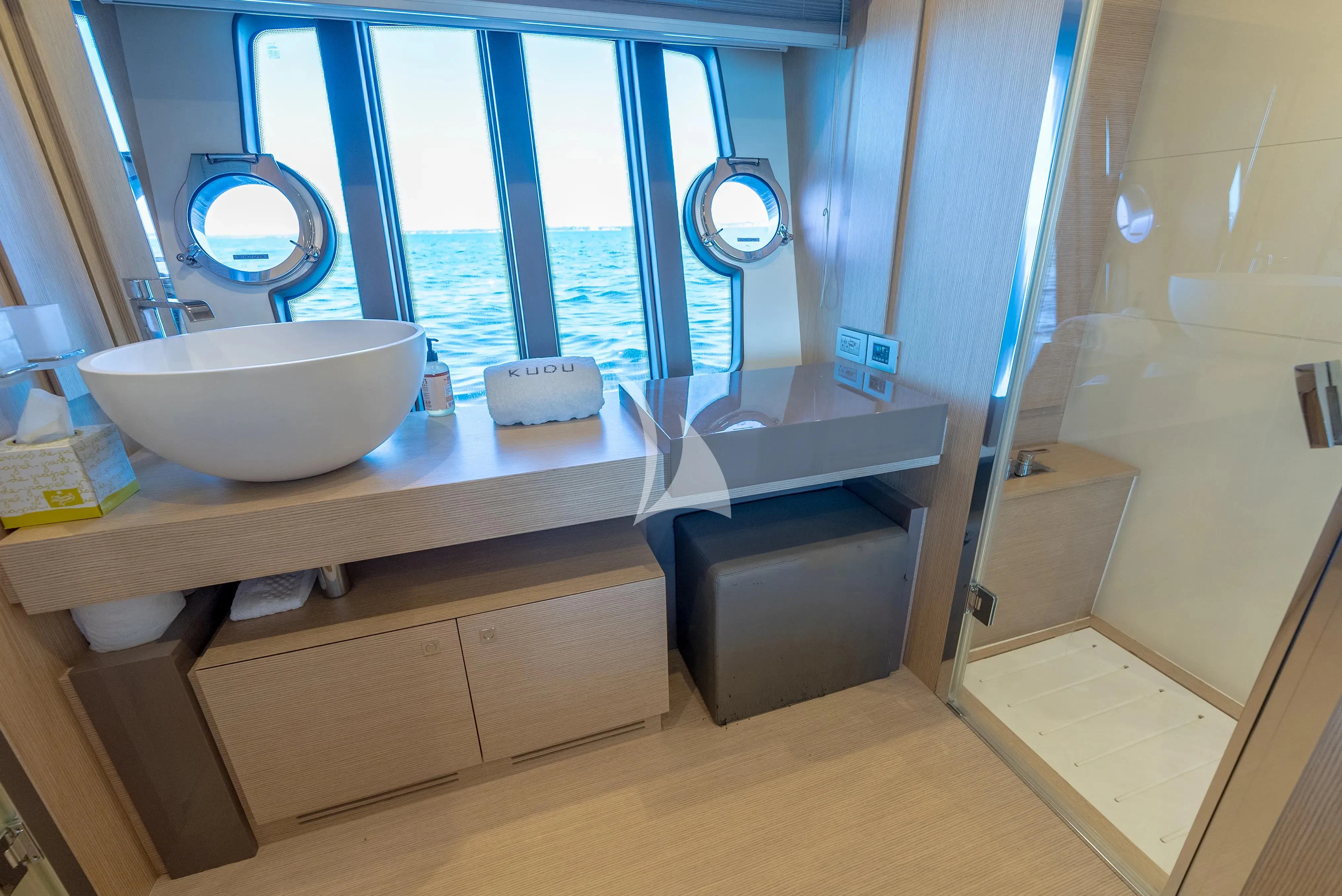 a bathroom with a sink and a mirror aboard KUDU Yacht for Sale