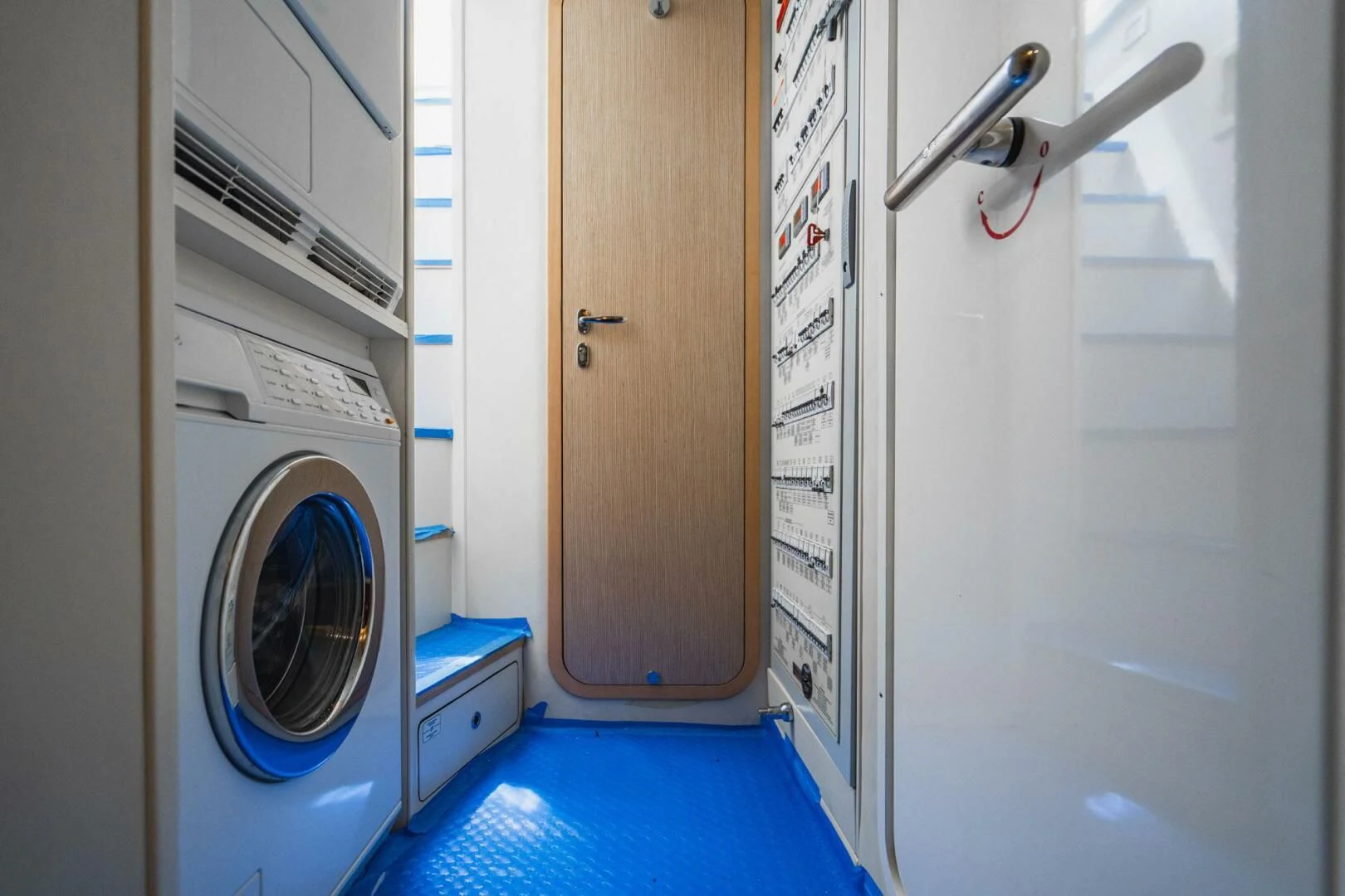 a room with a washing machine and dryer aboard KUDU Yacht for Sale