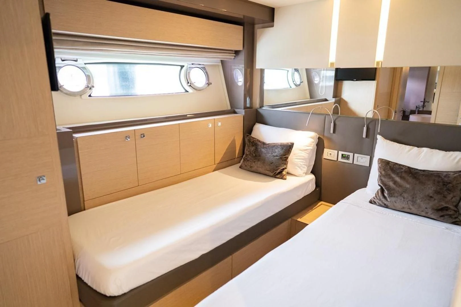 a room with a bed and a mirror aboard KUDU Yacht for Sale