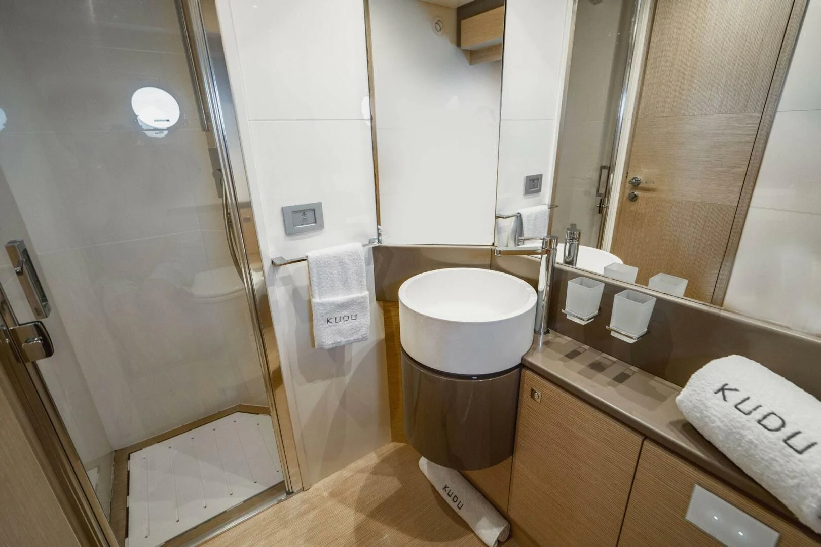 a bathroom with a glass shower aboard KUDU Yacht for Sale