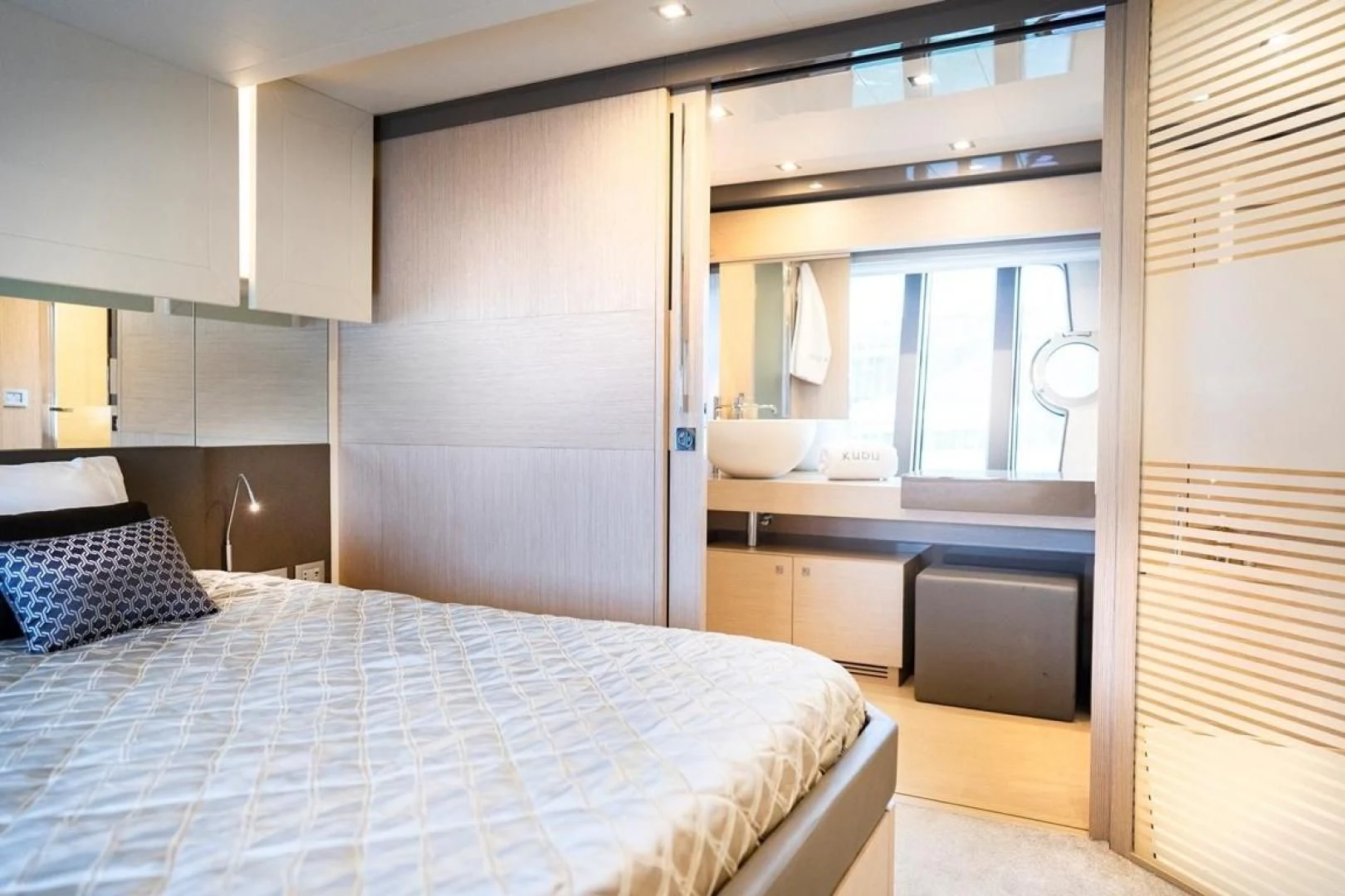 a bedroom with a bed aboard KUDU Yacht for Sale