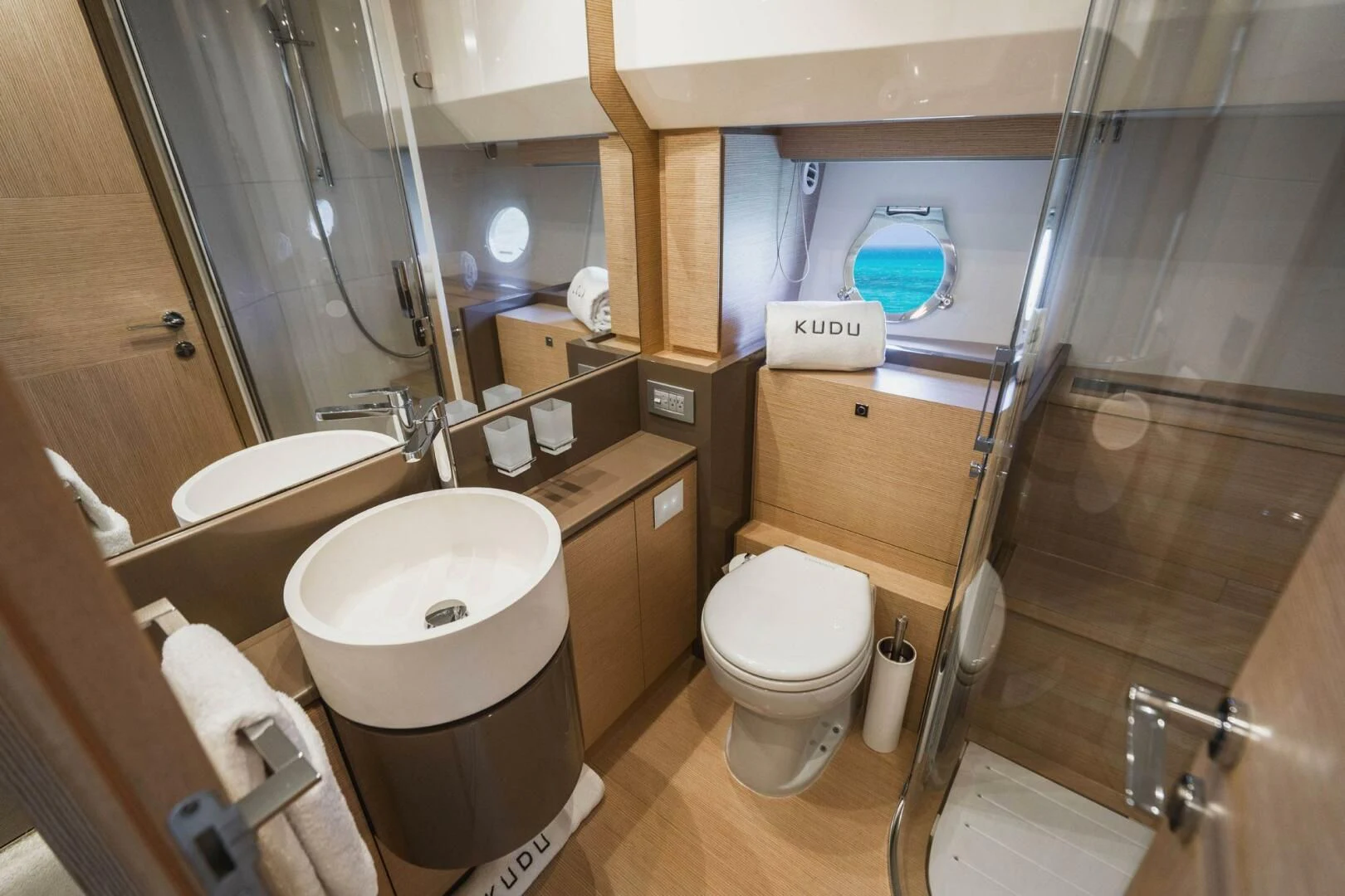 a bathroom with a toilet and a sink aboard KUDU Yacht for Sale