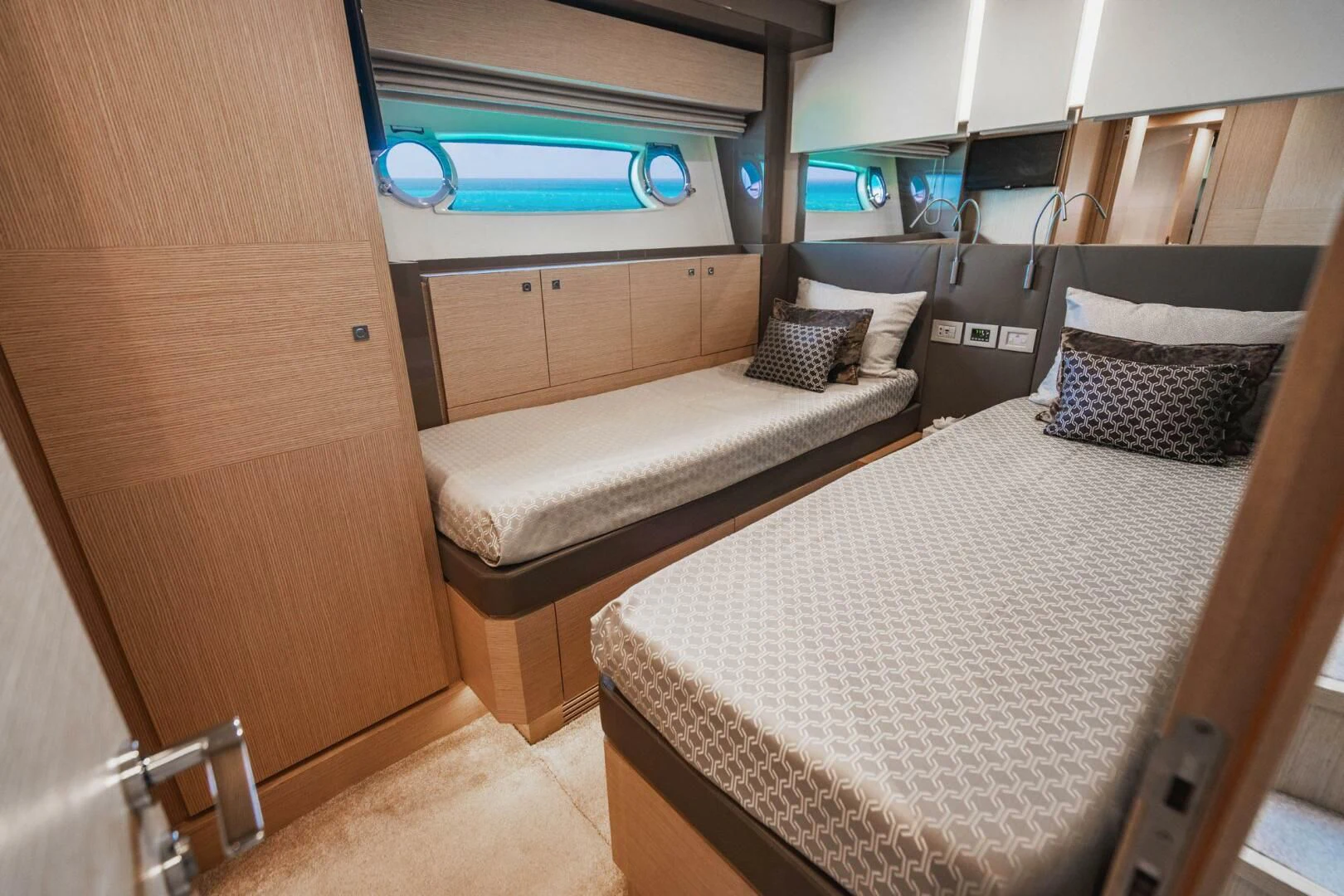 a room with a bed and a dresser aboard KUDU Yacht for Sale