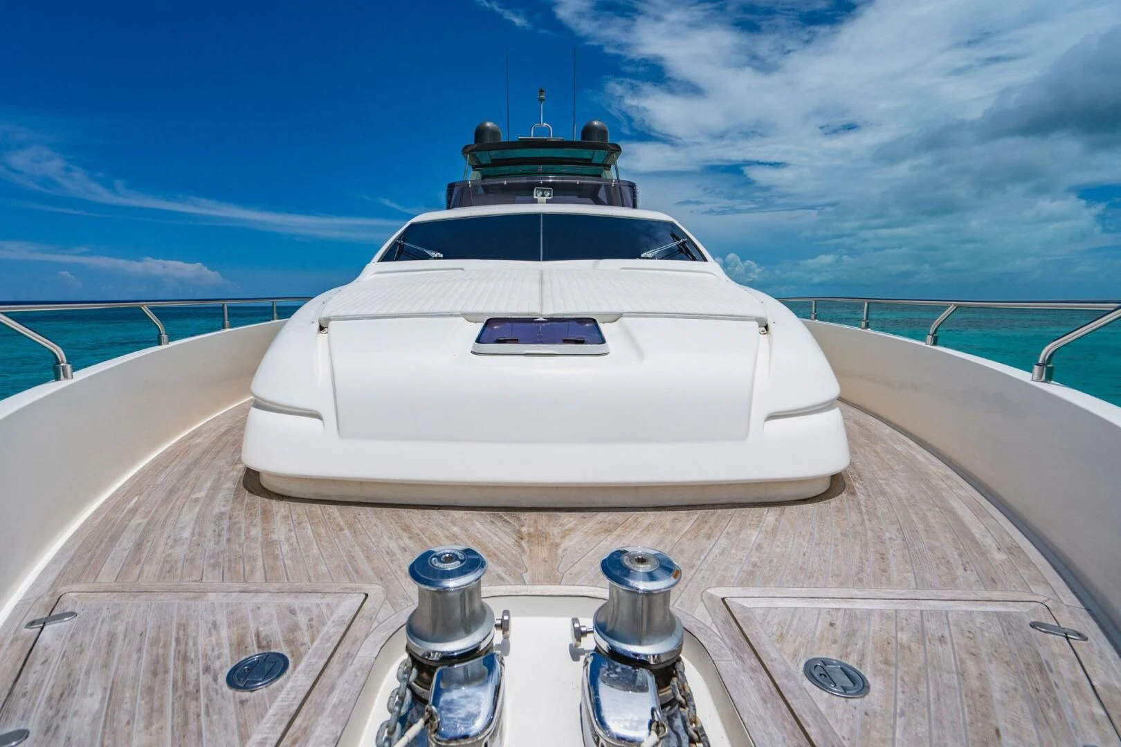 a white car on a wooden deck aboard KUDU Yacht for Sale