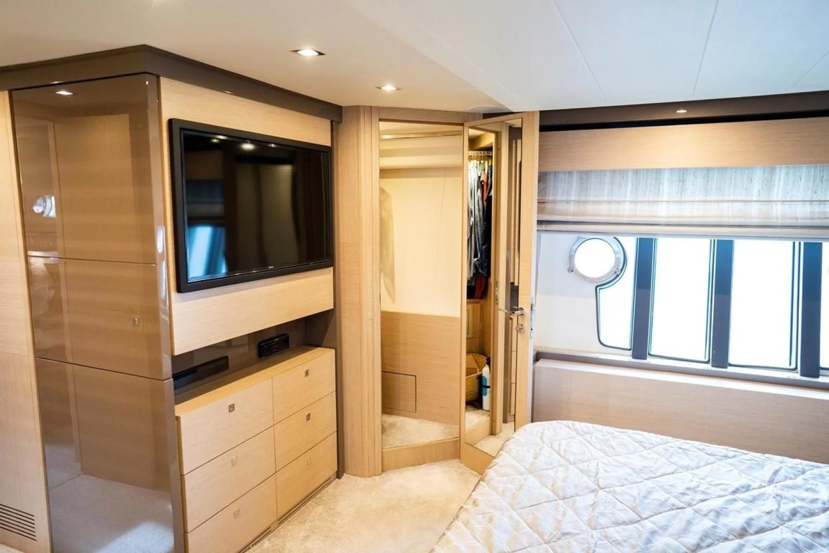 a bedroom with a bed and a closet aboard KUDU Yacht for Sale
