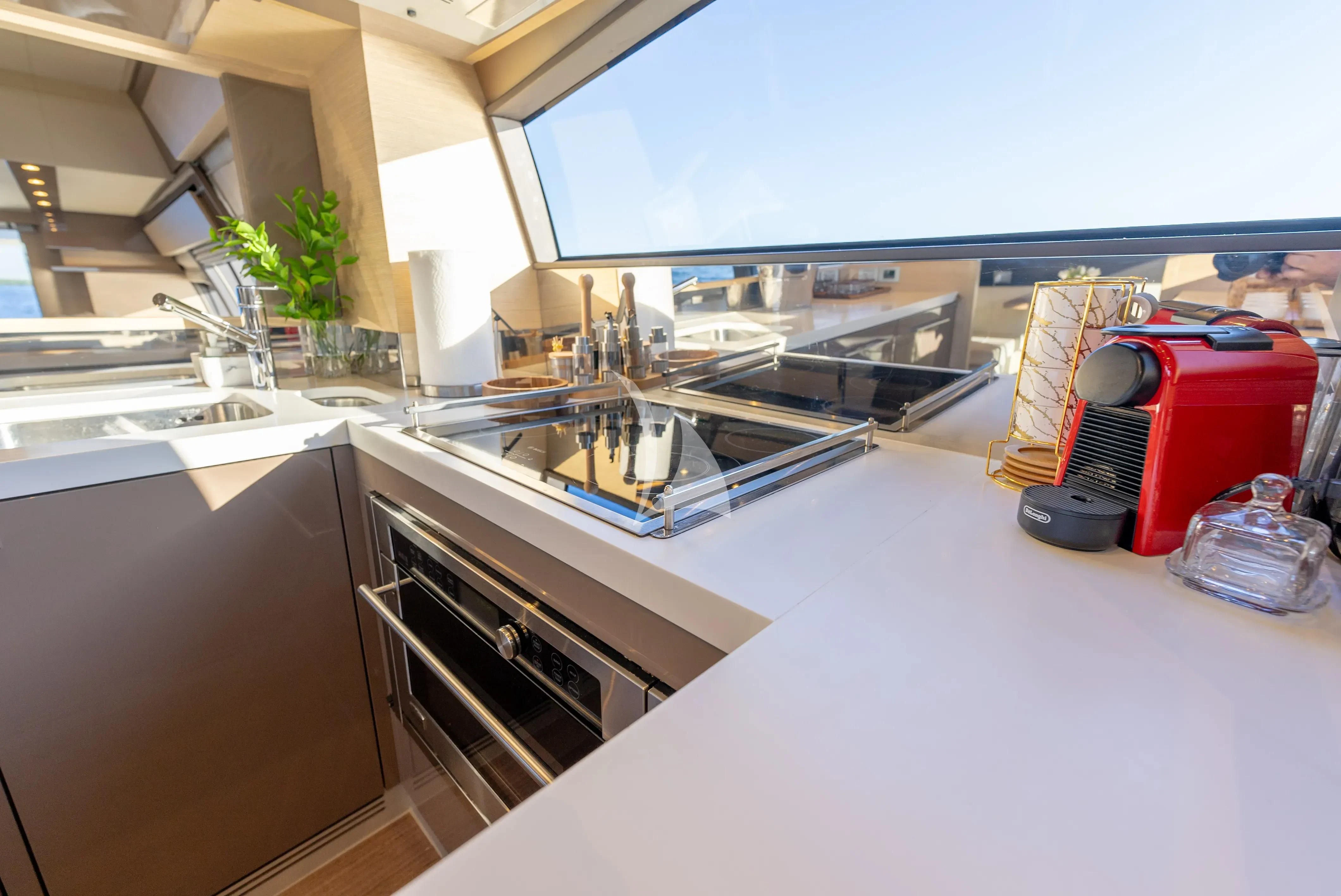a kitchen with a microwave oven and a toaster oven aboard KUDU Yacht for Sale