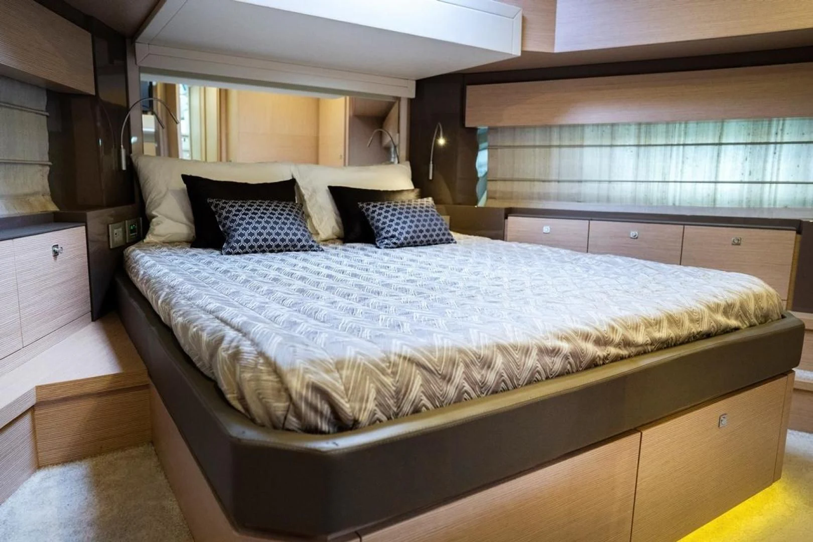 a bed with a blue comforter aboard KUDU Yacht for Sale