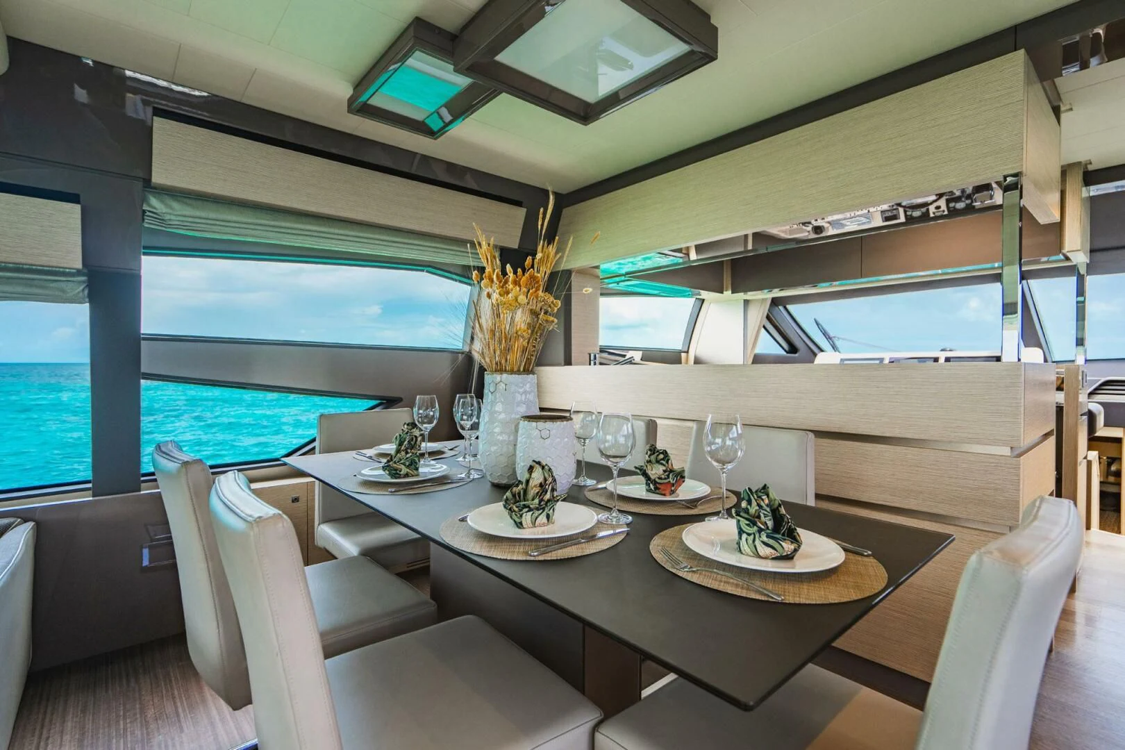a dining room with a large window aboard KUDU Yacht for Sale