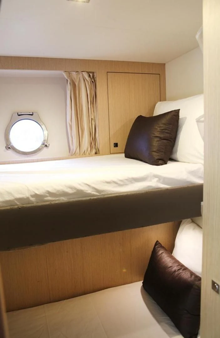 a bed with a mirror above it aboard KUDU Yacht for Sale