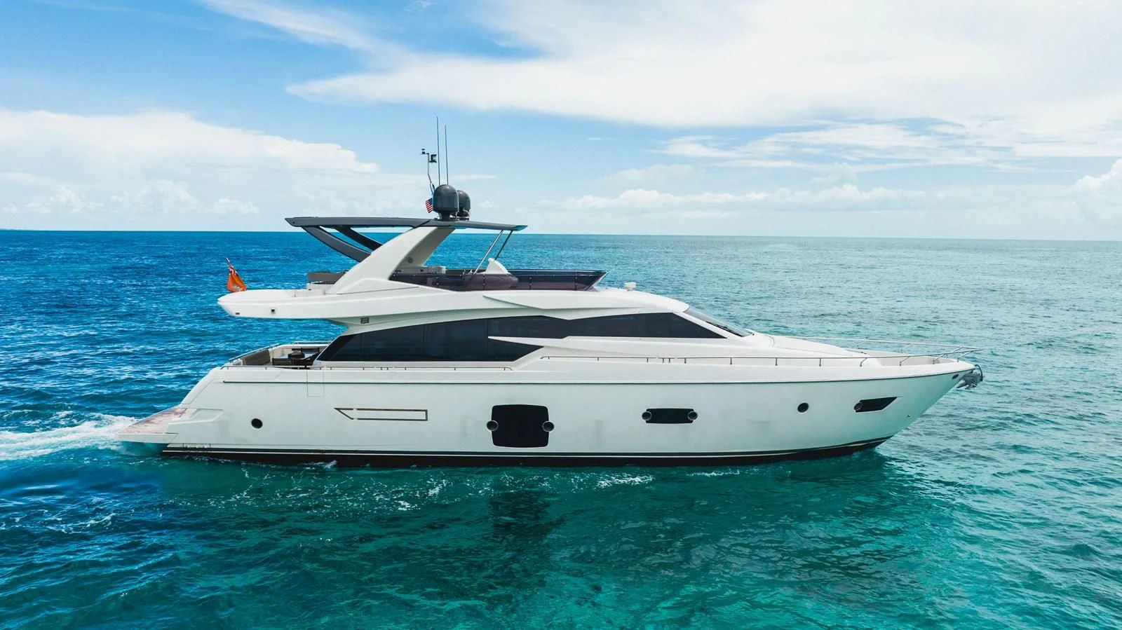 a white yacht in the water aboard KUDU Yacht for Sale