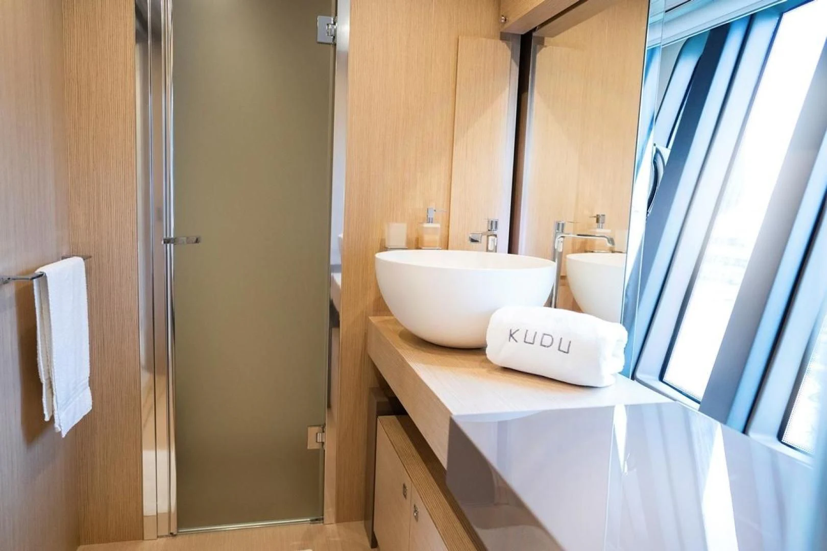 a bathroom with a sink and a mirror aboard KUDU Yacht for Sale