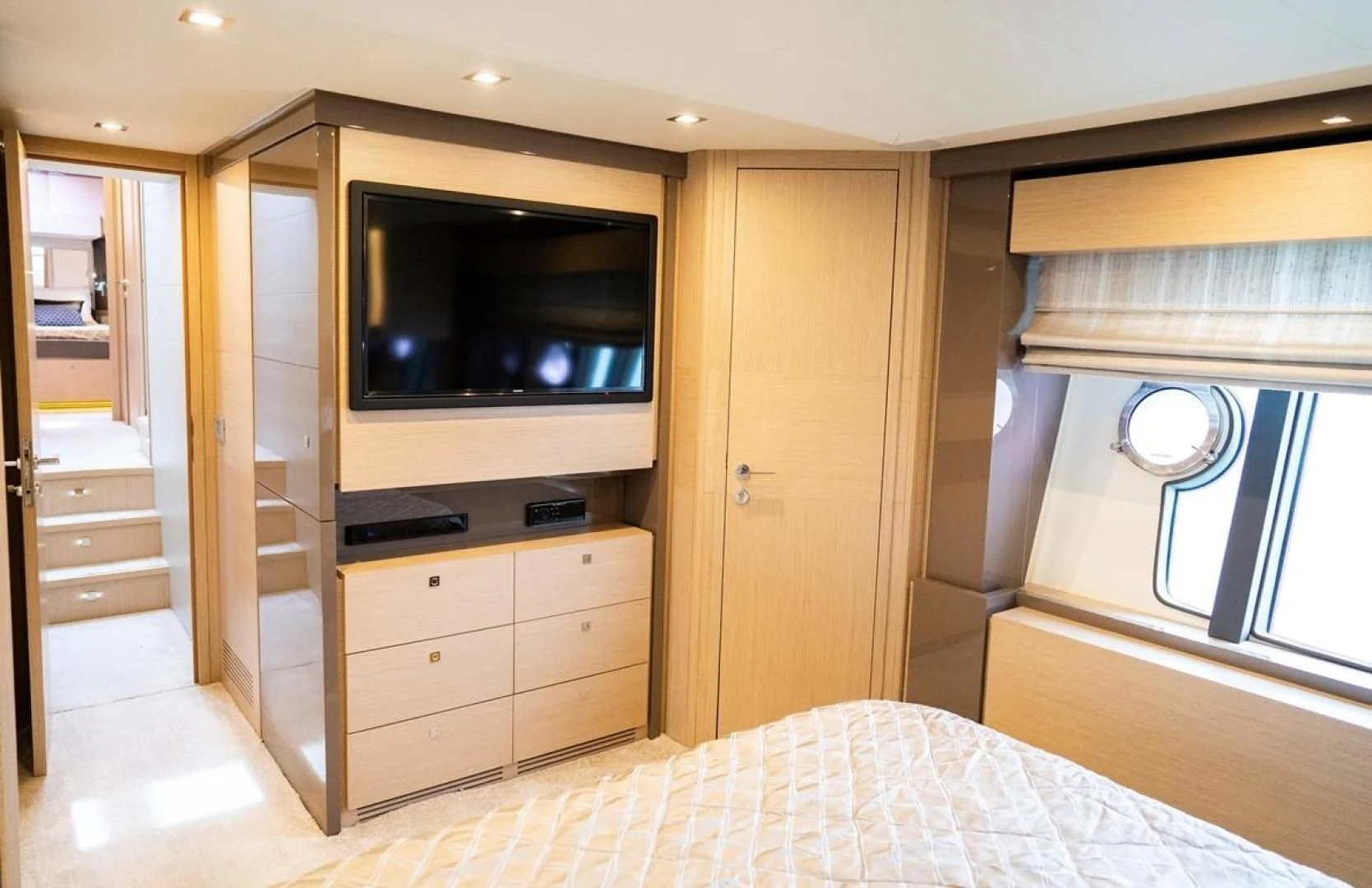 a bedroom with a bed and a television aboard KUDU Yacht for Sale