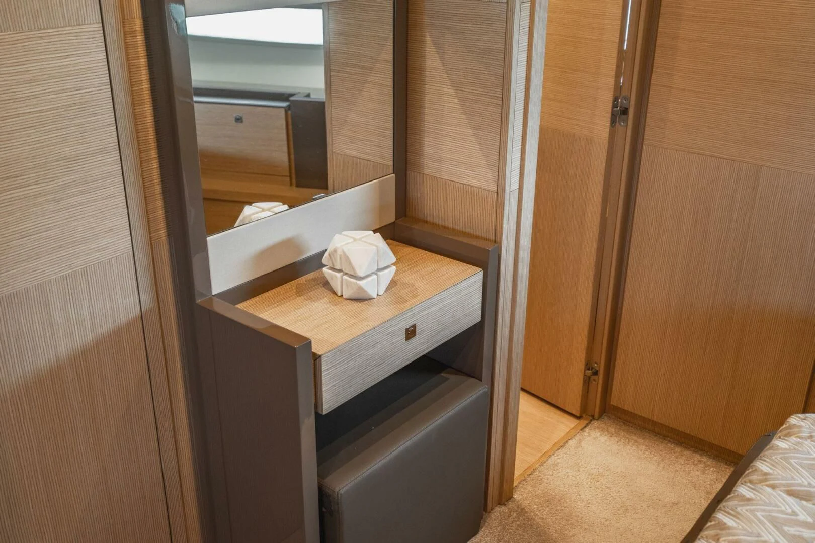 a room with a wood cabinet and a white towel on a shelf aboard KUDU Yacht for Sale
