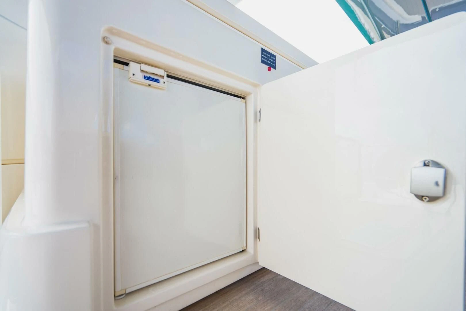 a white door with a handle aboard KUDU Yacht for Sale