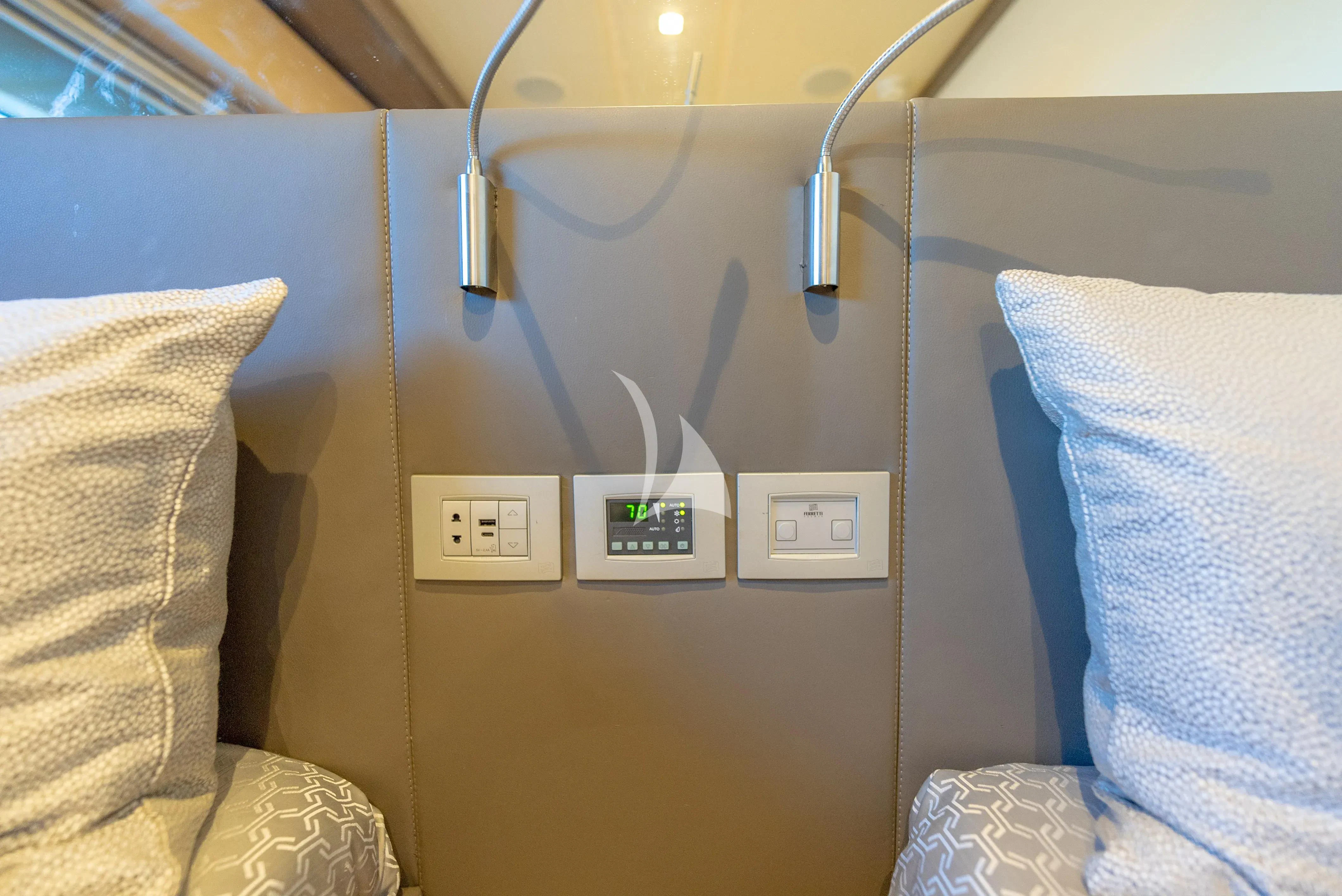 a bed with a light on it aboard KUDU Yacht for Sale