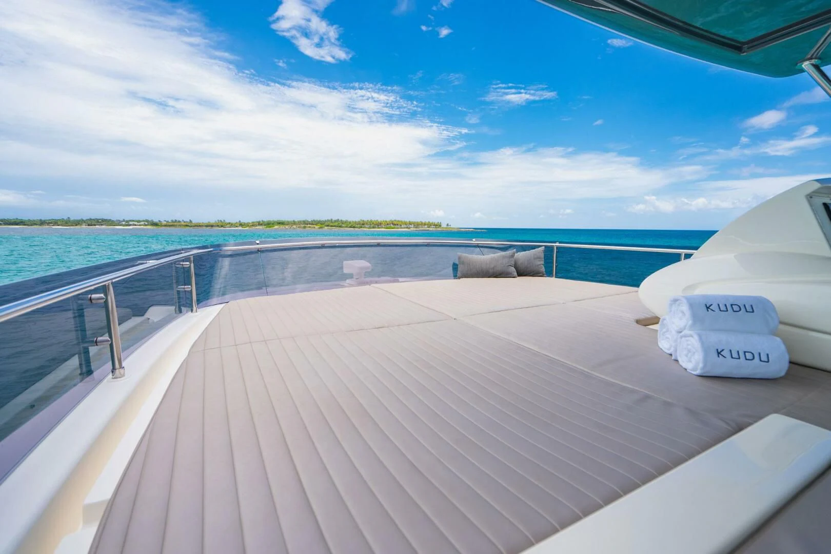a deck with a view of the beach and the ocean aboard KUDU Yacht for Sale