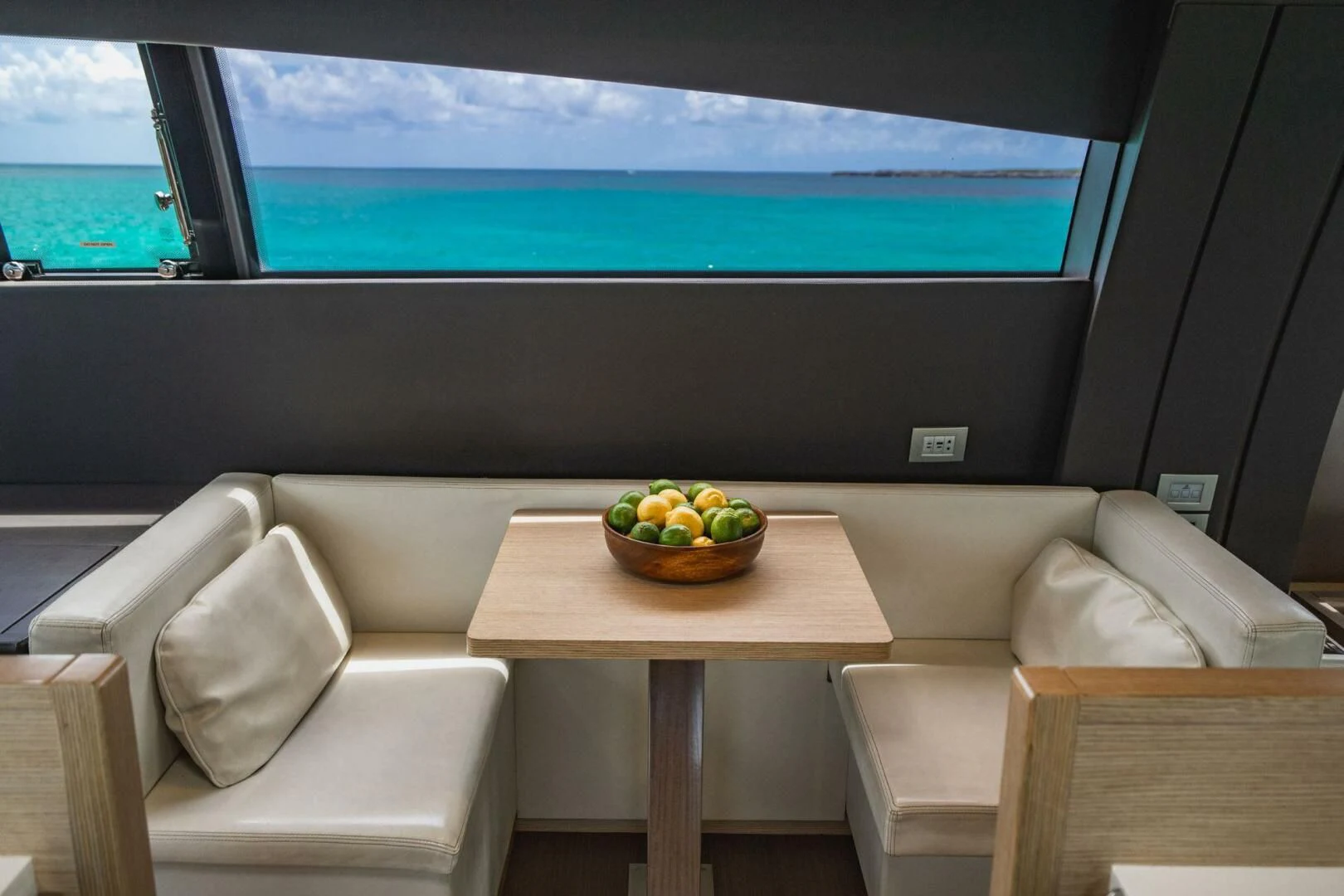 a room with a table and chairs aboard KUDU Yacht for Sale