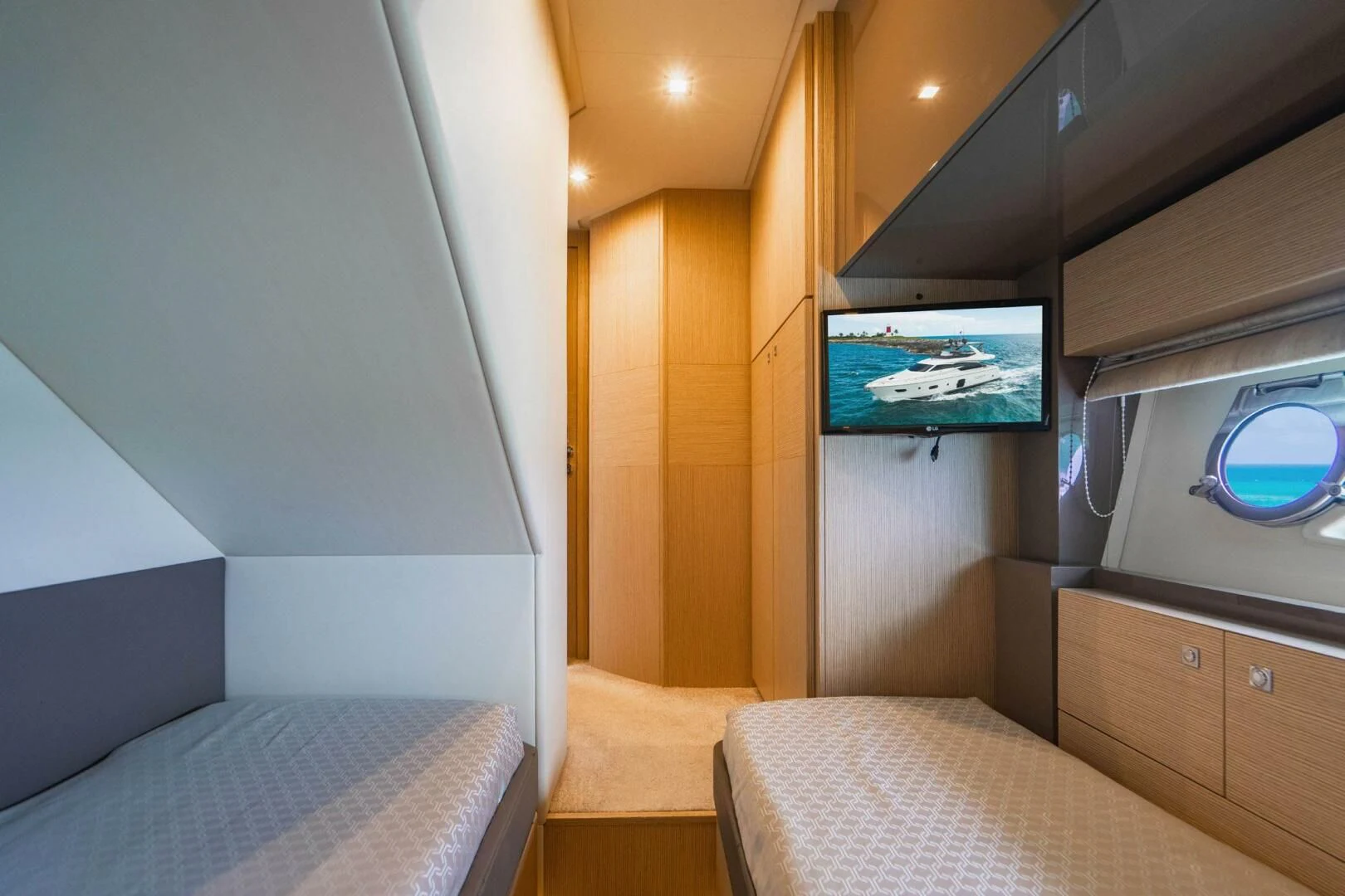 a room with a bed and a tv on the wall aboard KUDU Yacht for Sale