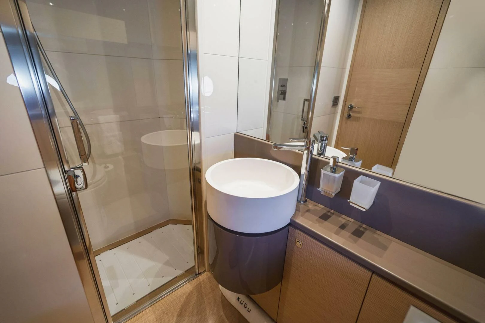 a bathroom with a glass shower aboard KUDU Yacht for Sale