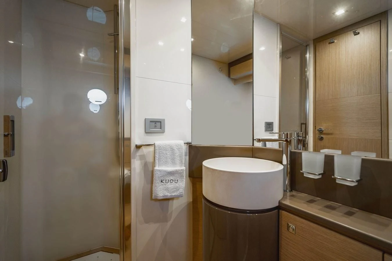 a bathroom with a toilet and a mirror aboard KUDU Yacht for Sale