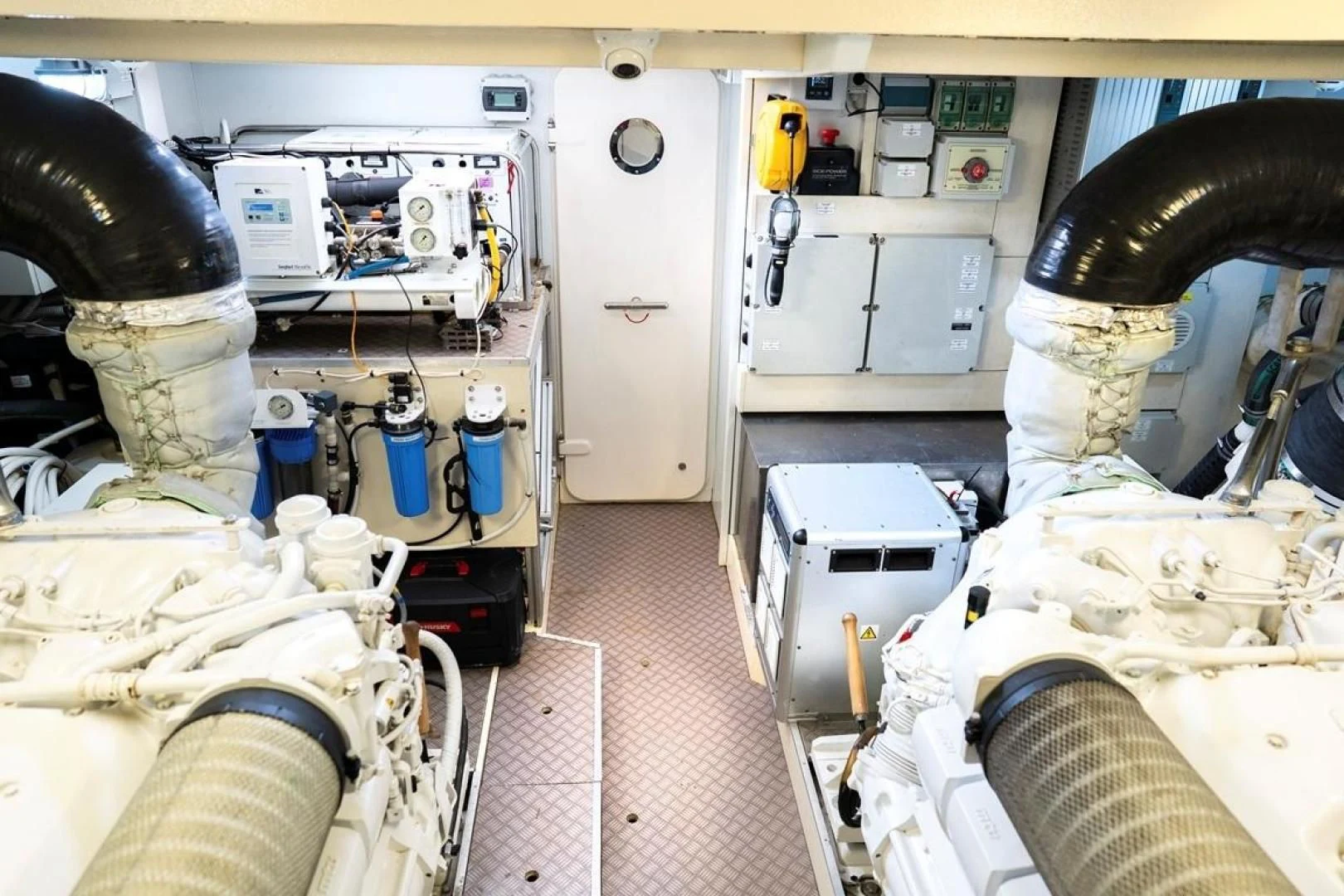 a room with white machines aboard KUDU Yacht for Sale