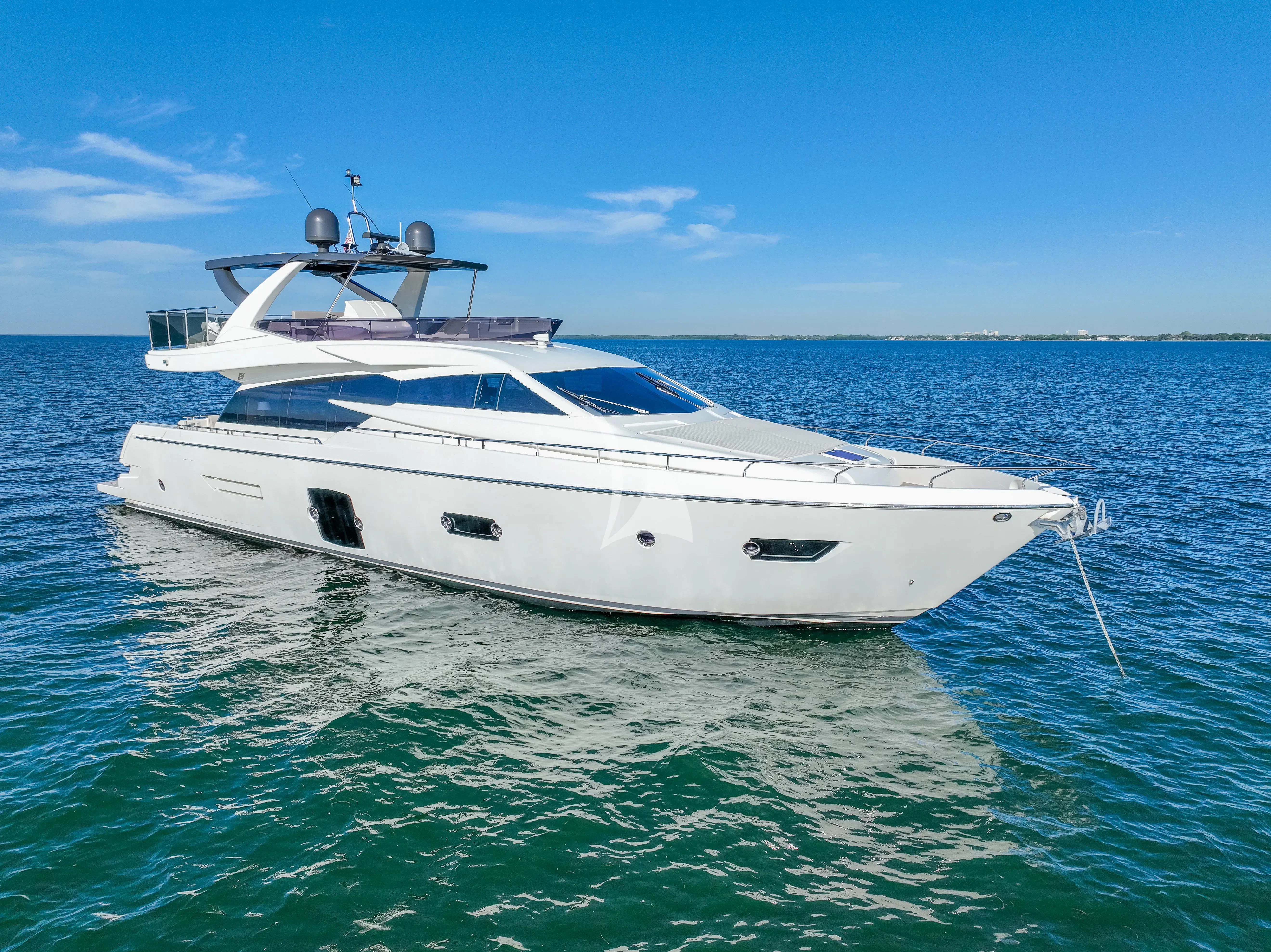 a white yacht in the water aboard KUDU Yacht for Sale