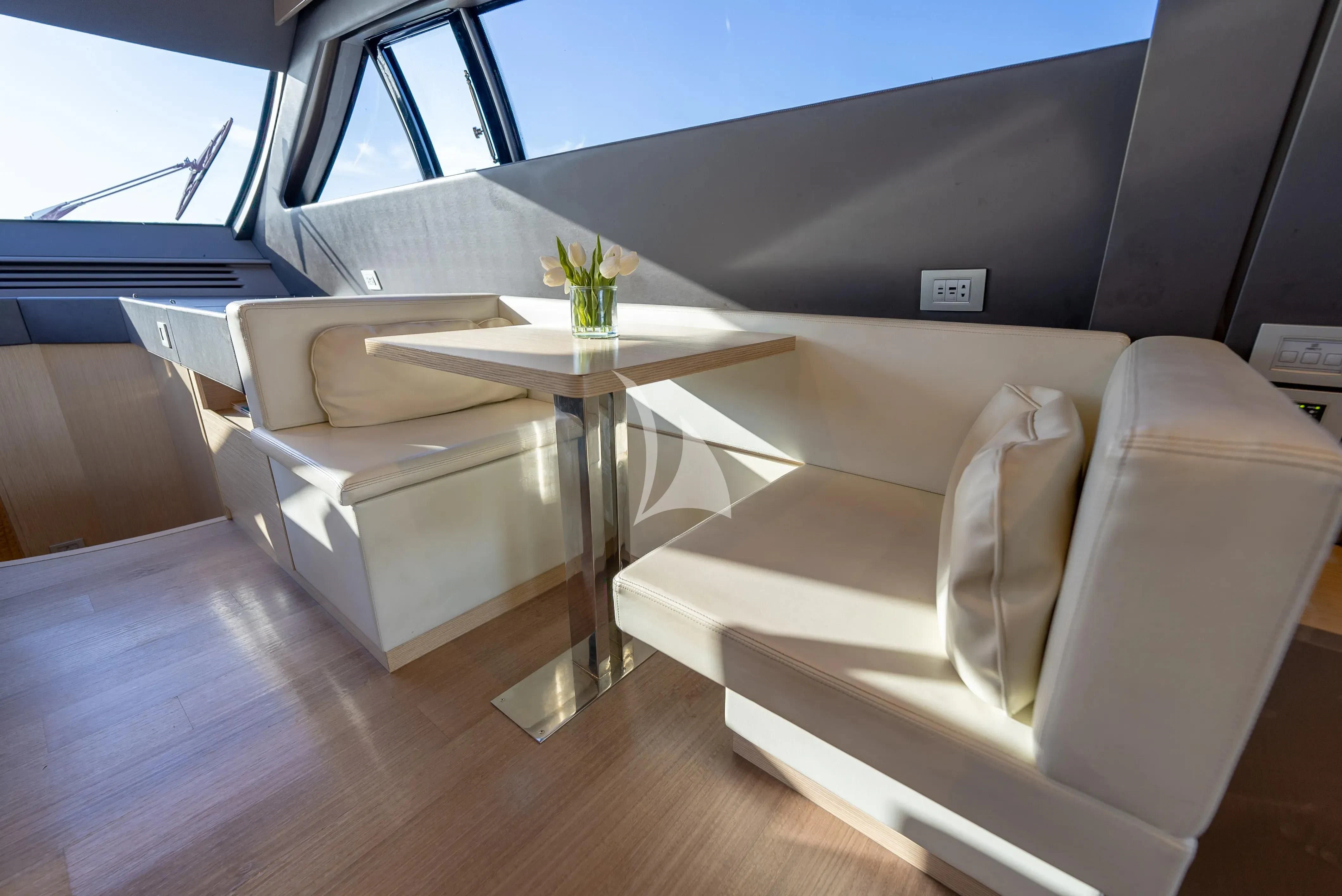 a room with a table and chairs aboard KUDU Yacht for Sale