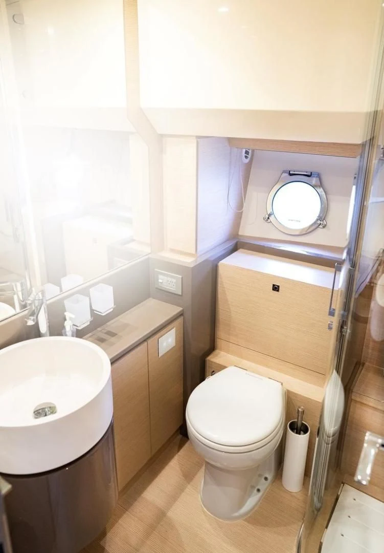 a bathroom with a sink toilet and a mirror aboard KUDU Yacht for Sale