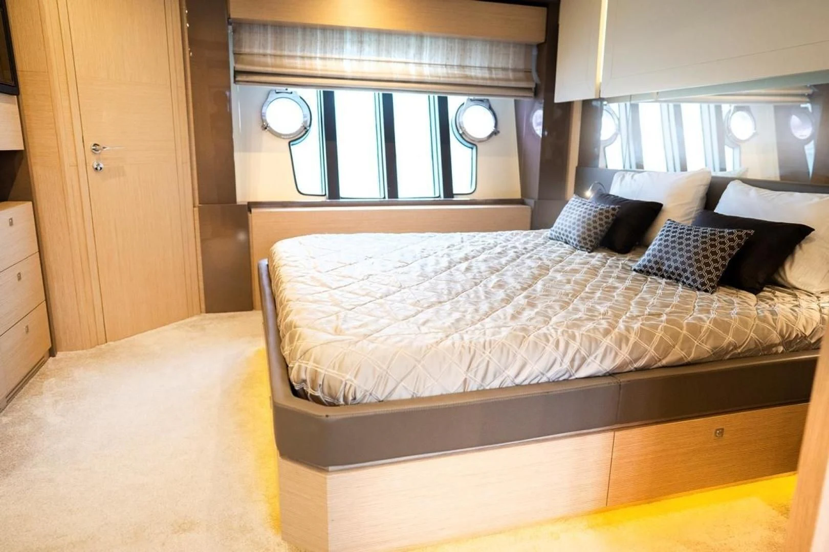 a bed with a large mirror above it aboard KUDU Yacht for Sale