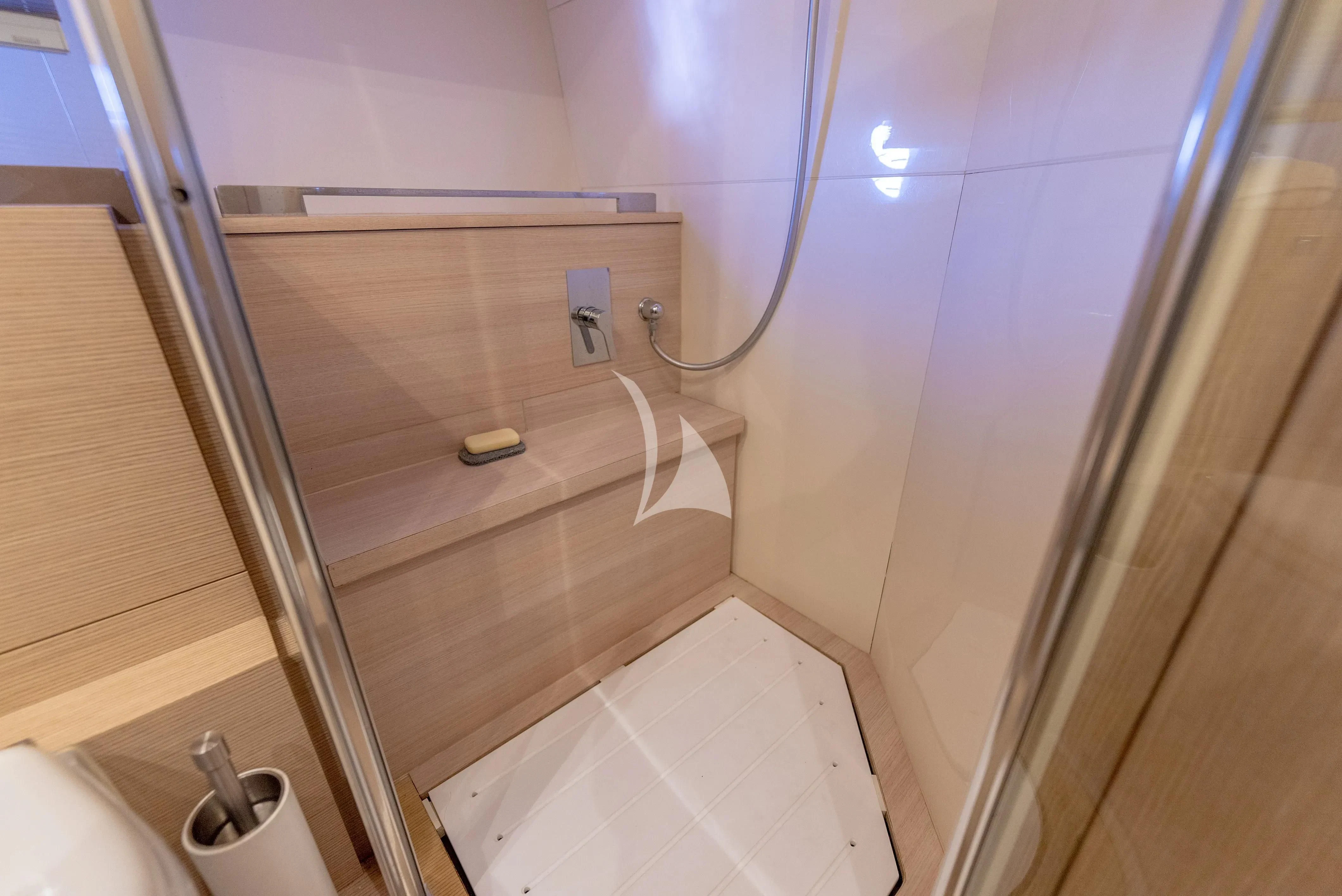 a bathroom with a shower and a toilet aboard KUDU Yacht for Sale