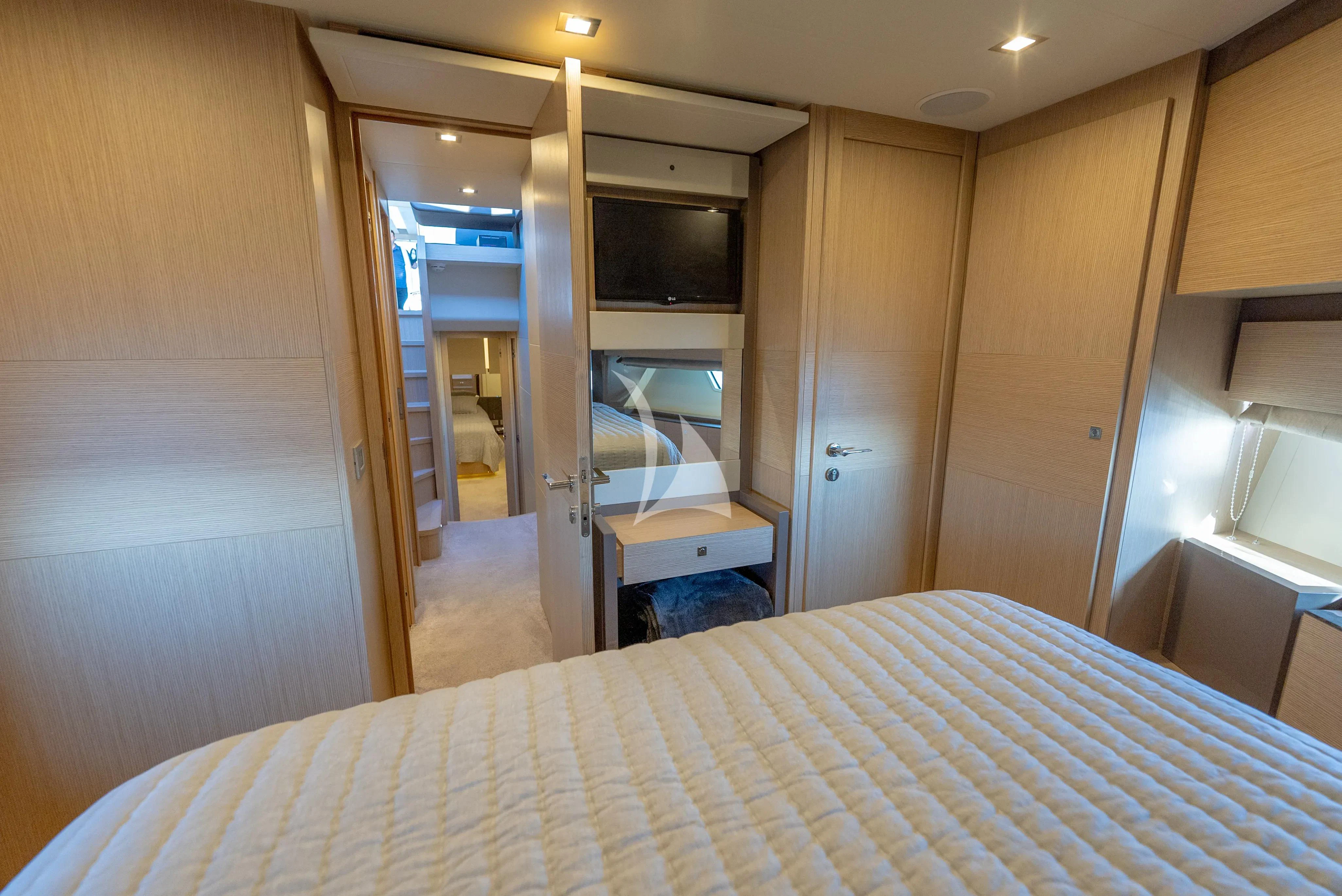 a bedroom with a bed and a desk aboard KUDU Yacht for Sale