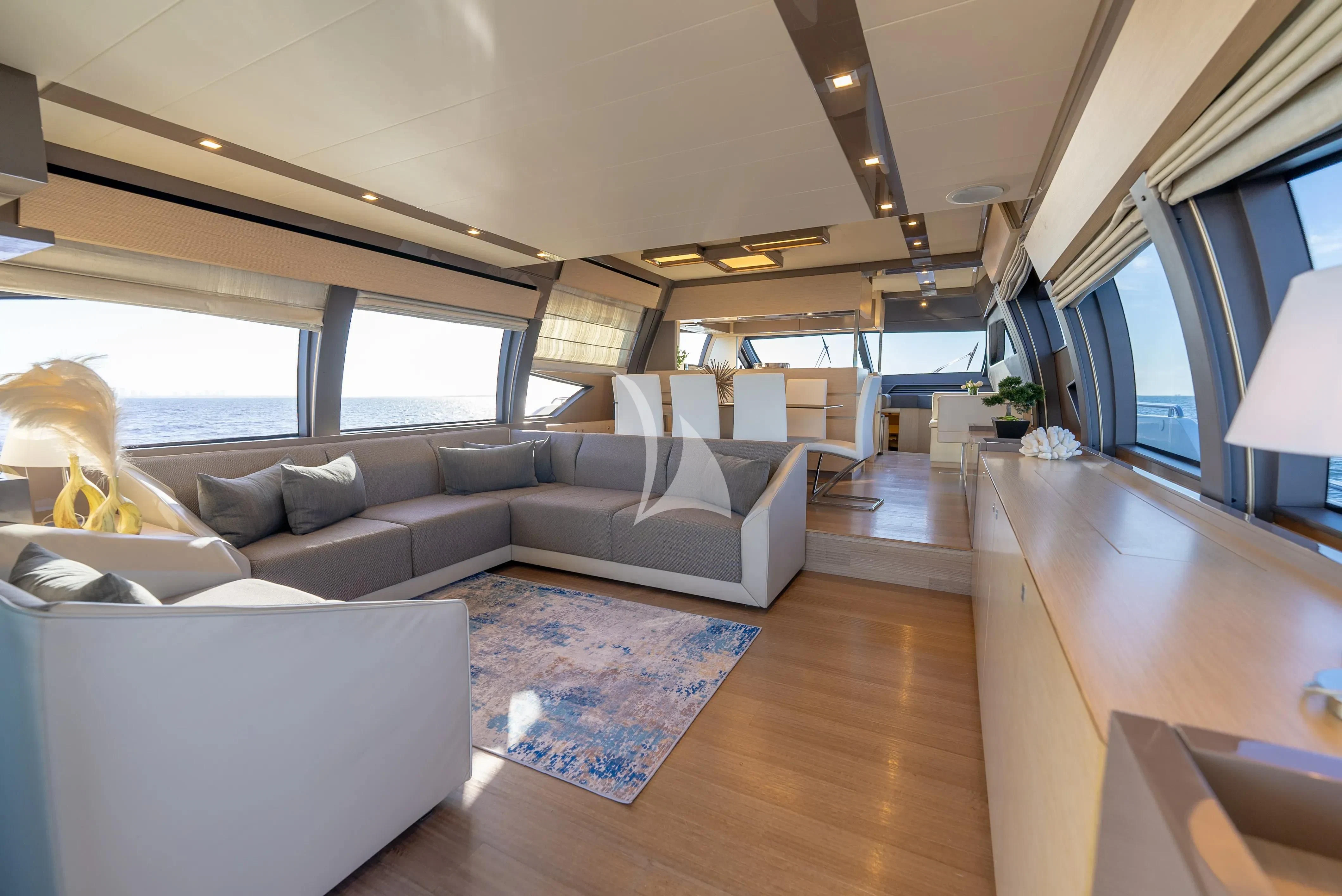 a living room with a couch and a large window aboard KUDU Yacht for Sale