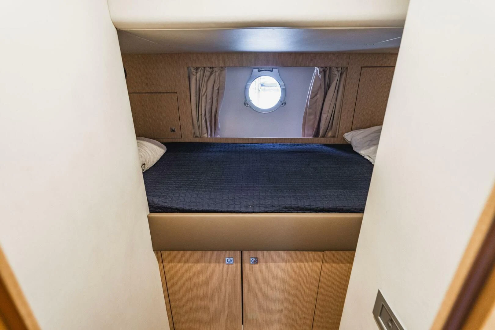 a room with a bed and a mirror aboard KUDU Yacht for Sale
