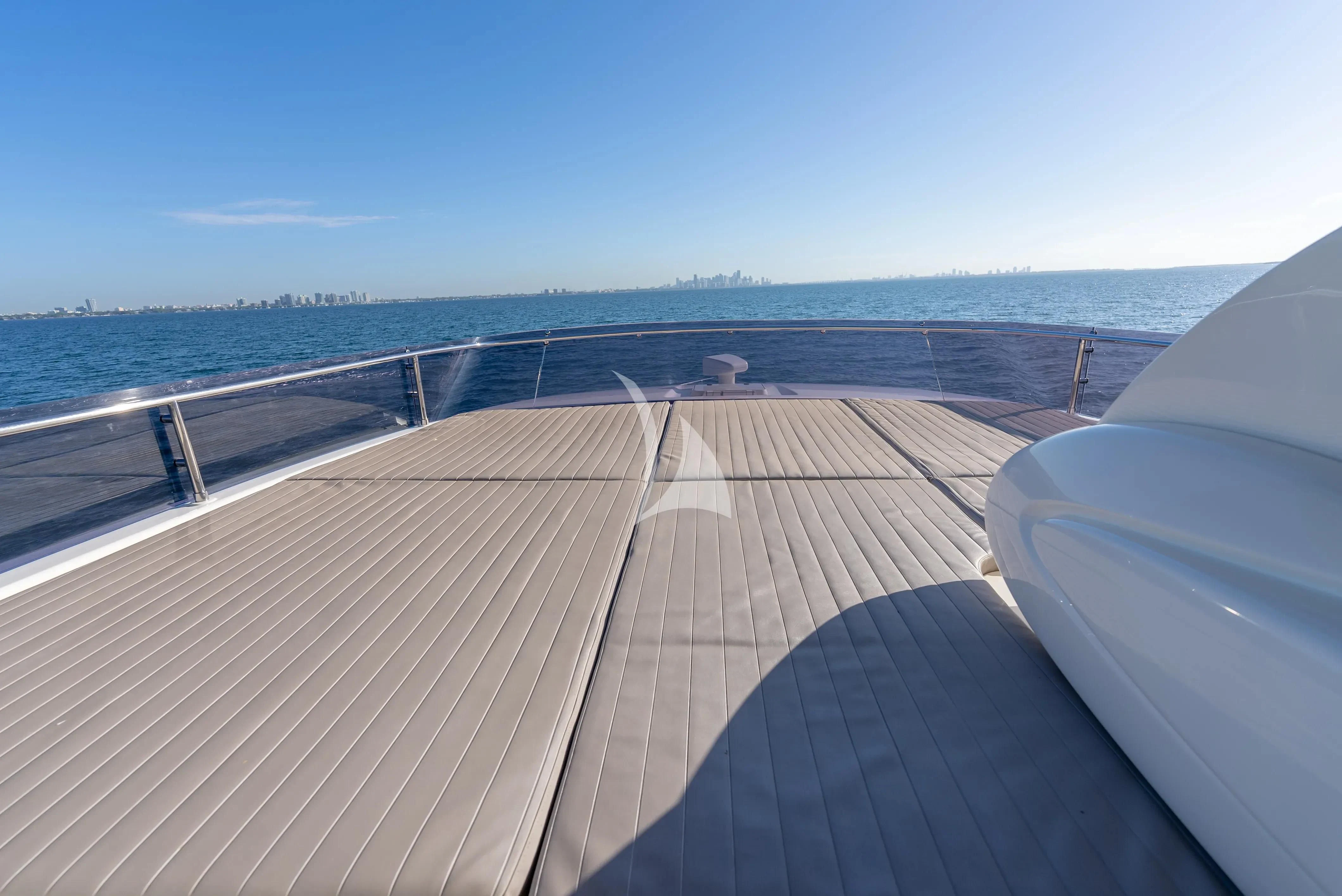 a deck overlooking a beach aboard KUDU Yacht for Sale