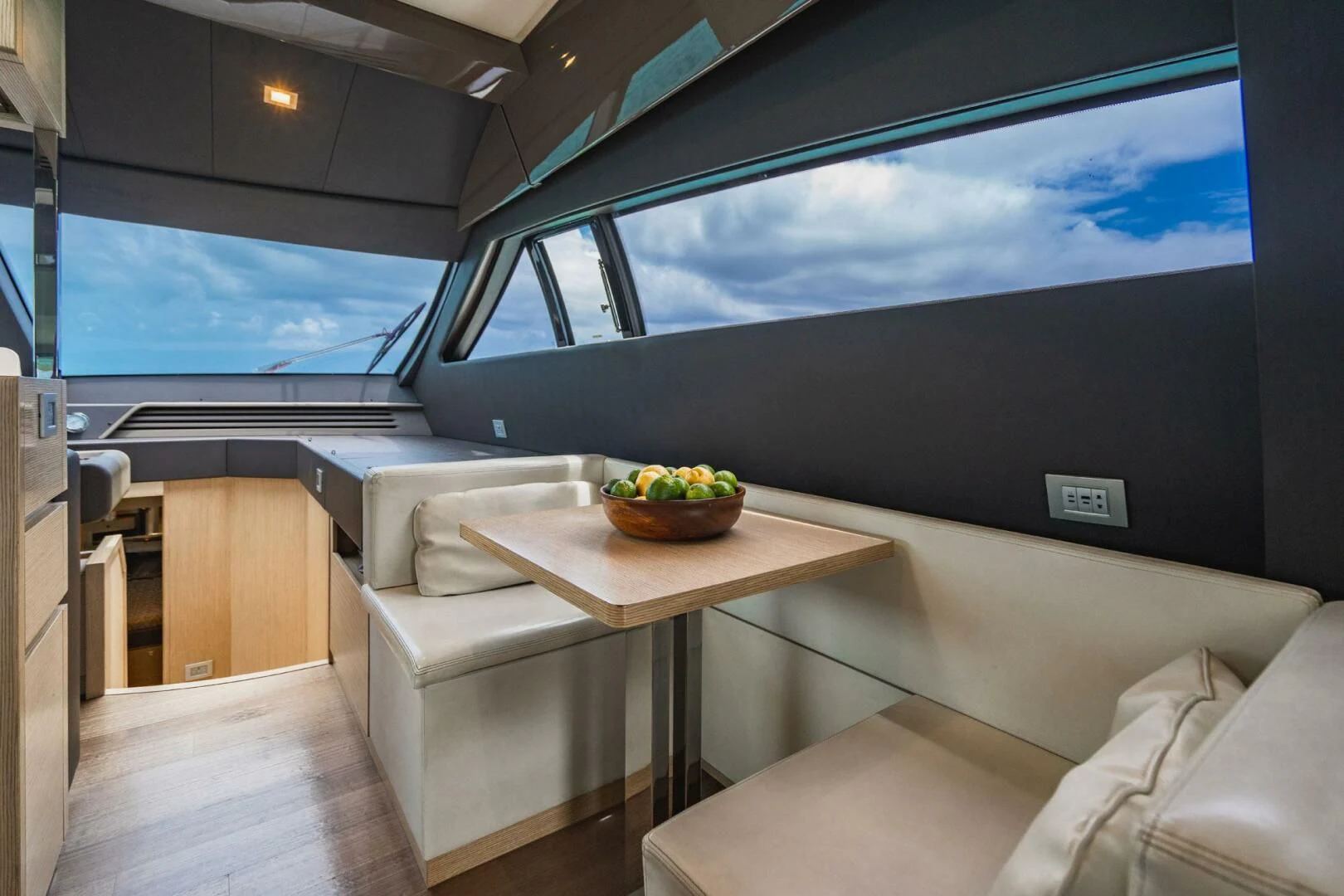 a room with a table and a tv aboard KUDU Yacht for Sale