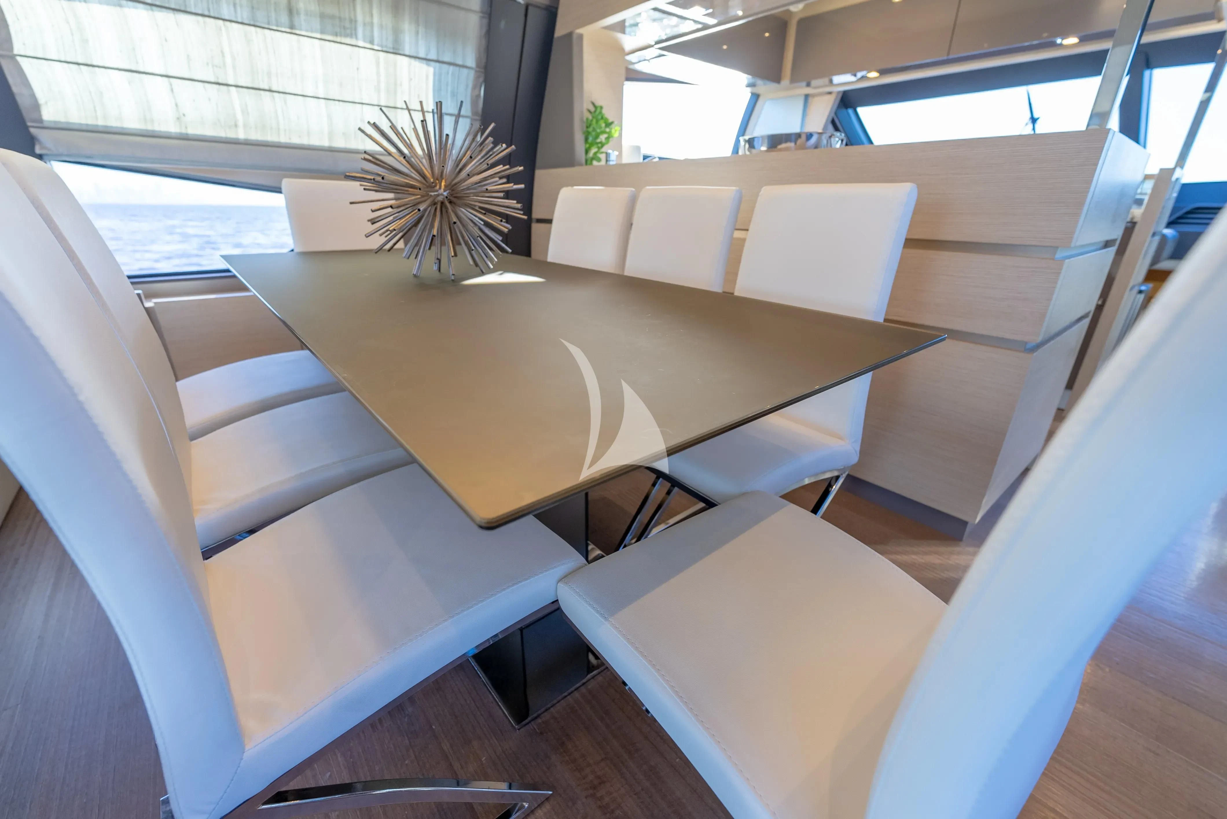 a table with chairs around it aboard KUDU Yacht for Sale
