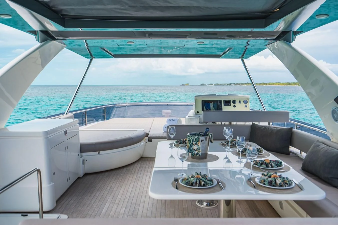 a table with plates and food on it aboard KUDU Yacht for Sale
