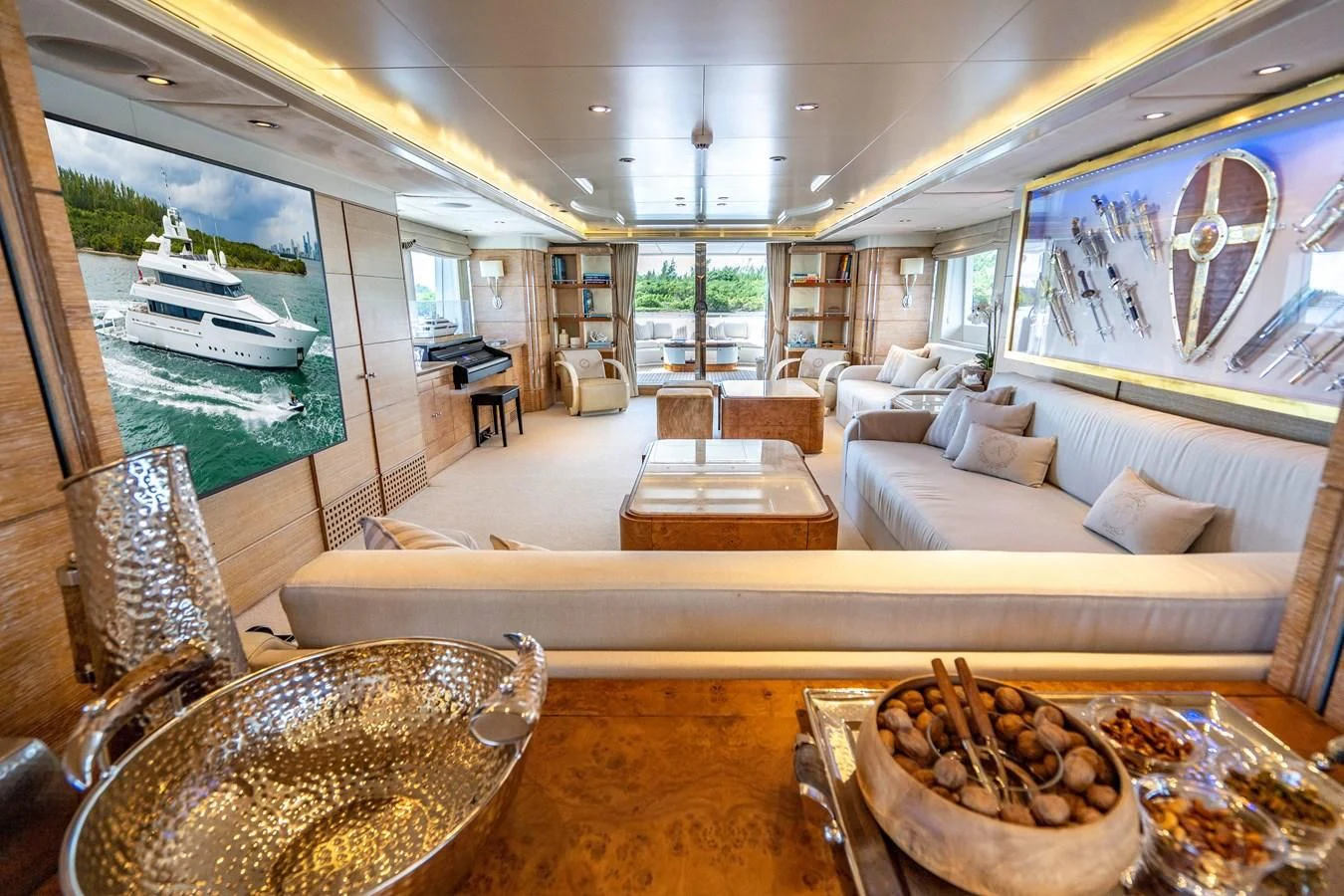 a living room with a large glass table and a large window aboard ARTEMISEA Yacht for Sale