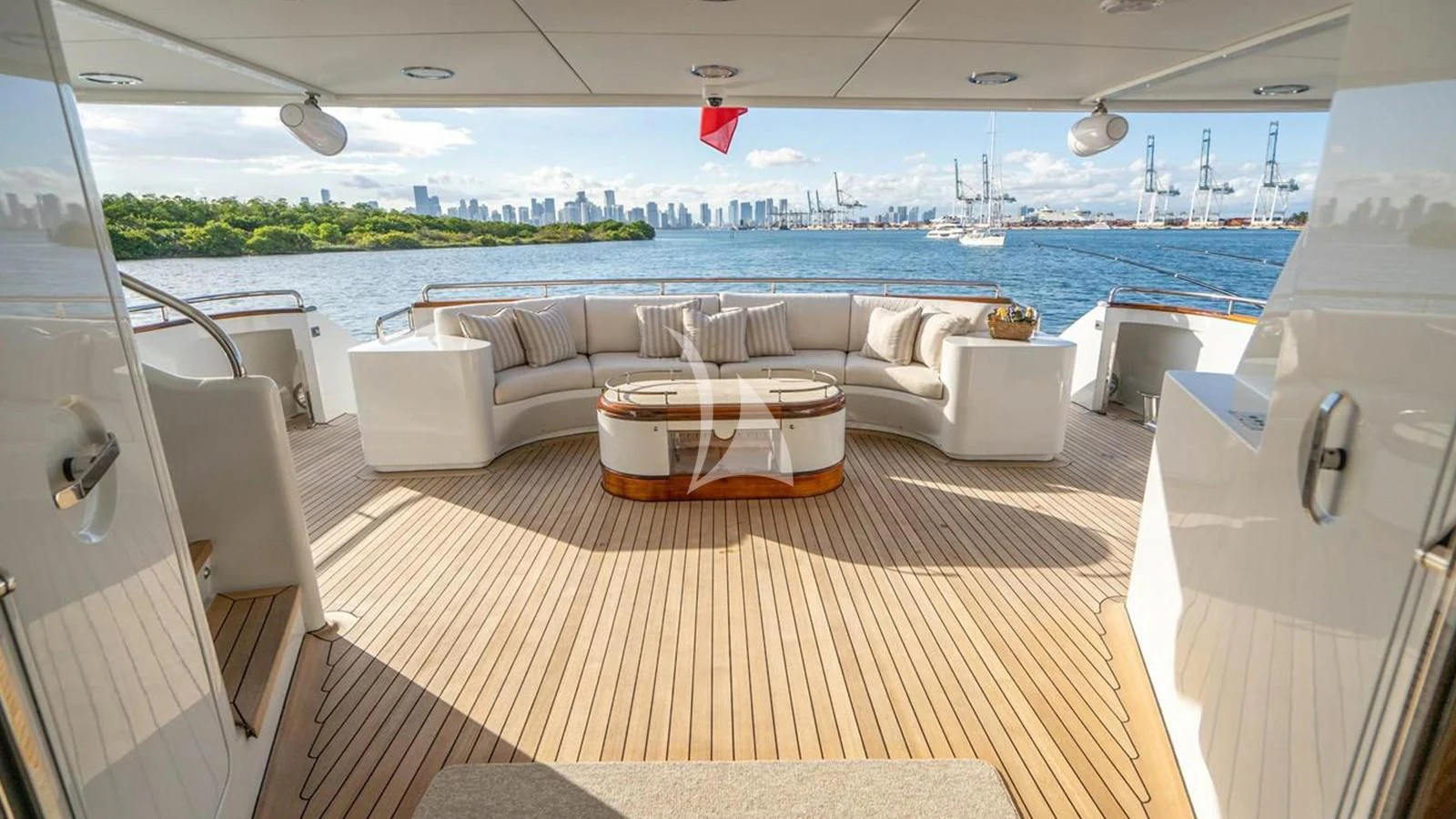 a room with a couch and a table and a view of the water aboard ARTEMISEA Yacht for Sale