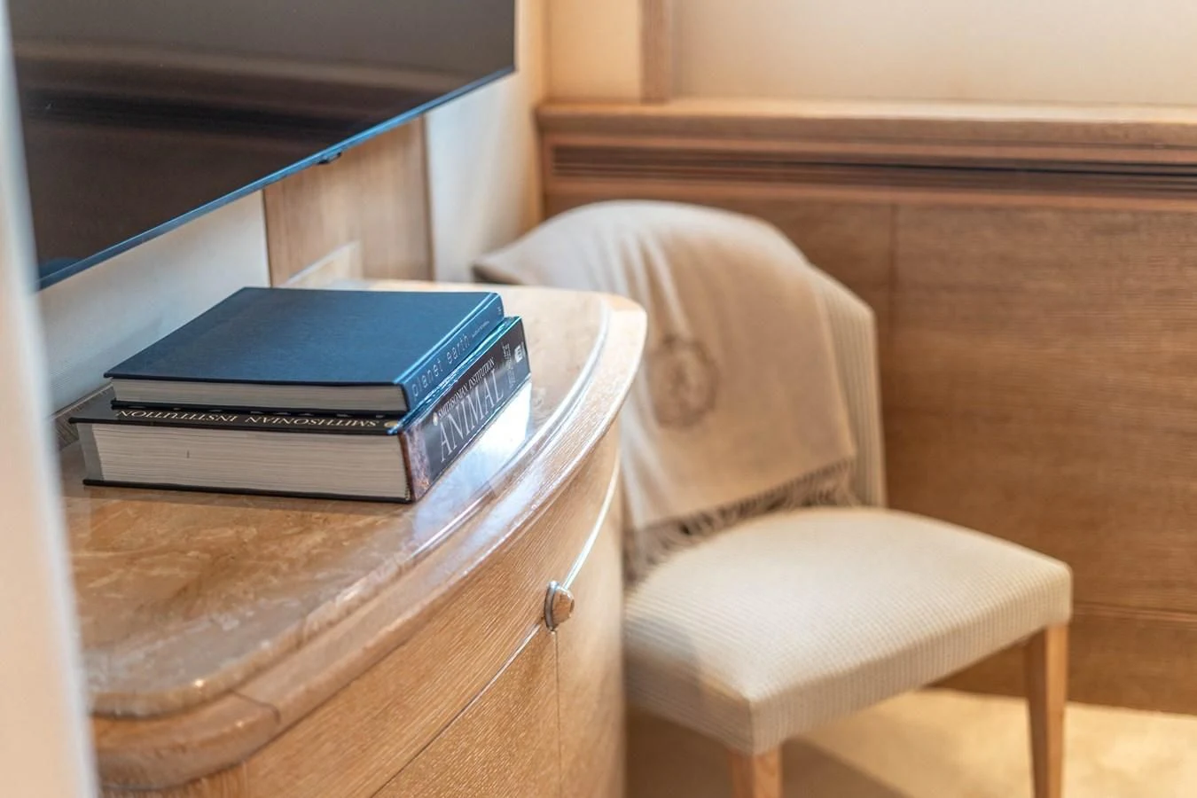 a chair with a stack of books on it aboard ARTEMISEA Yacht for Sale