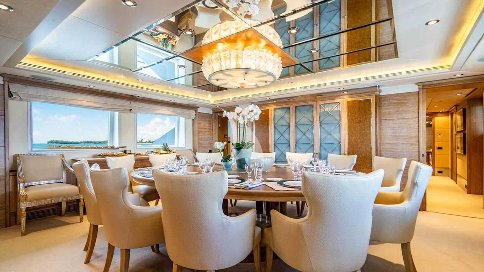 a room with tables and chairs aboard ARTEMISEA Yacht for Sale