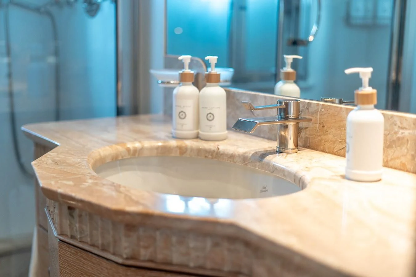 a bathroom sink with a few soap dispensers aboard ARTEMISEA Yacht for Sale