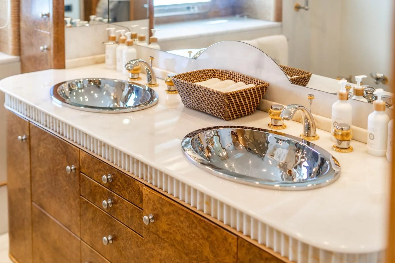 a bathroom with a sink and a basket aboard ARTEMISEA Yacht for Sale