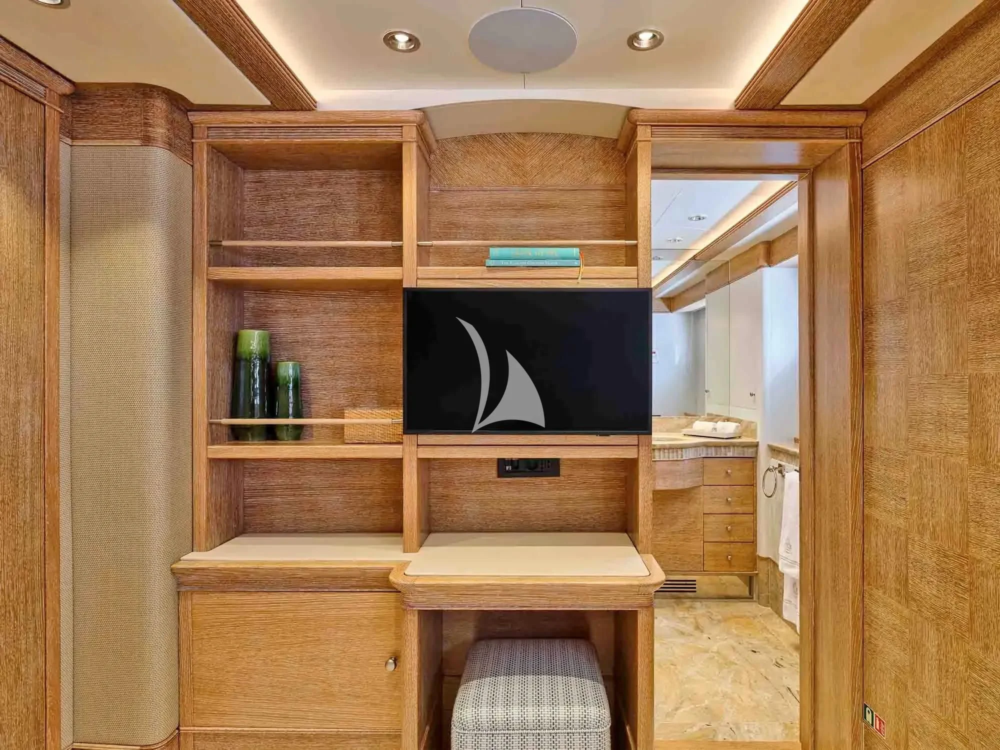 a room with a wood cabinet and a black screen on the wall aboard ARTEMISEA Yacht for Sale