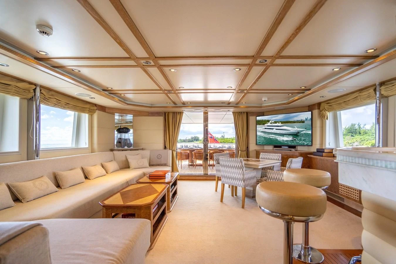a living room with a large screen aboard ARTEMISEA Yacht for Sale