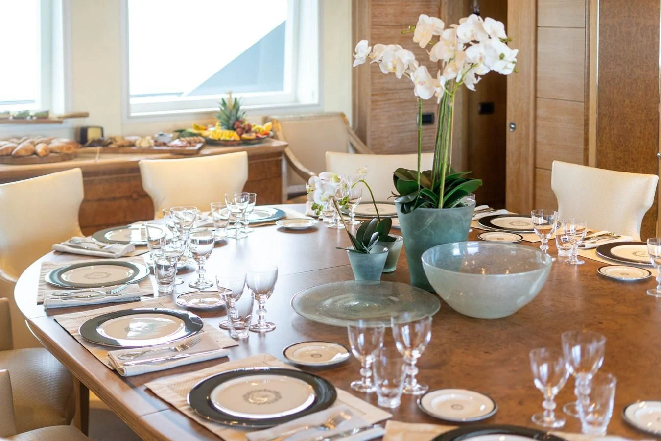 a table set with plates and glasses aboard ARTEMISEA Yacht for Sale