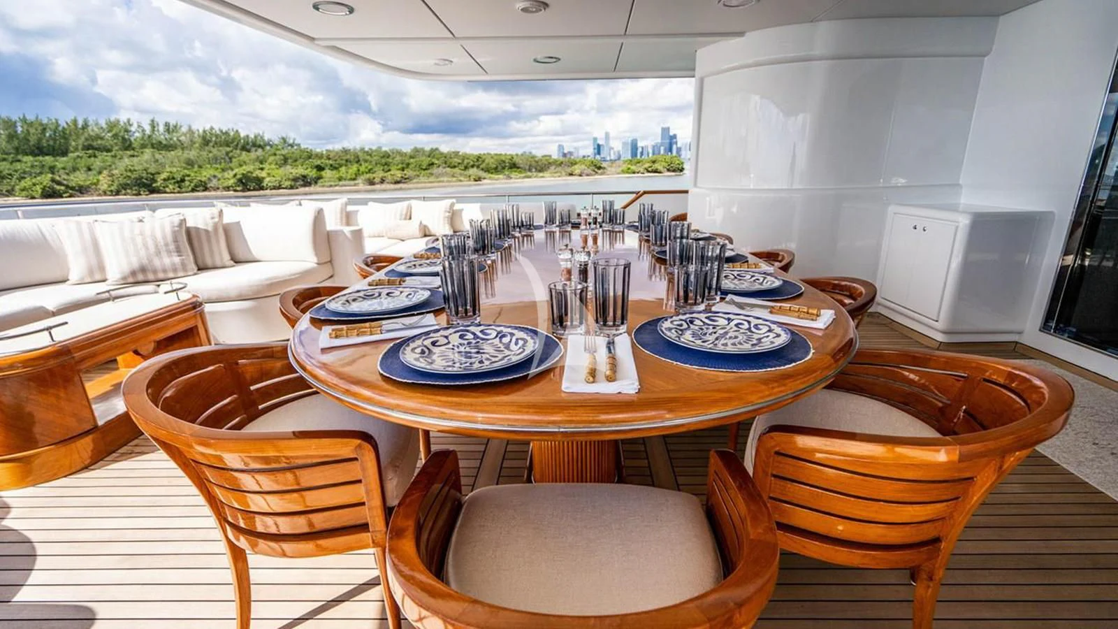 a table with plates and chairs aboard ARTEMISEA Yacht for Sale