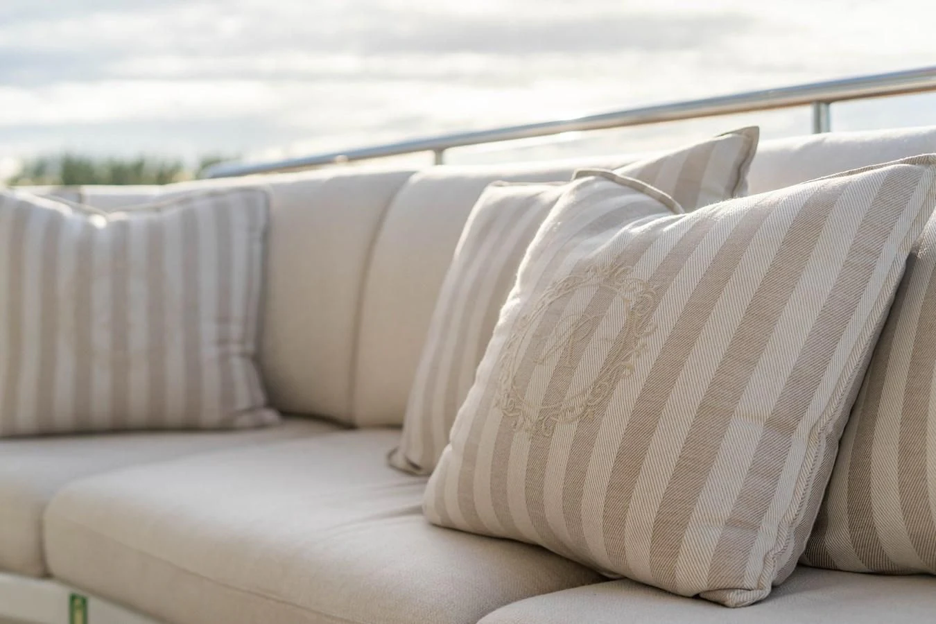 a couch with pillows on it aboard ARTEMISEA Yacht for Sale
