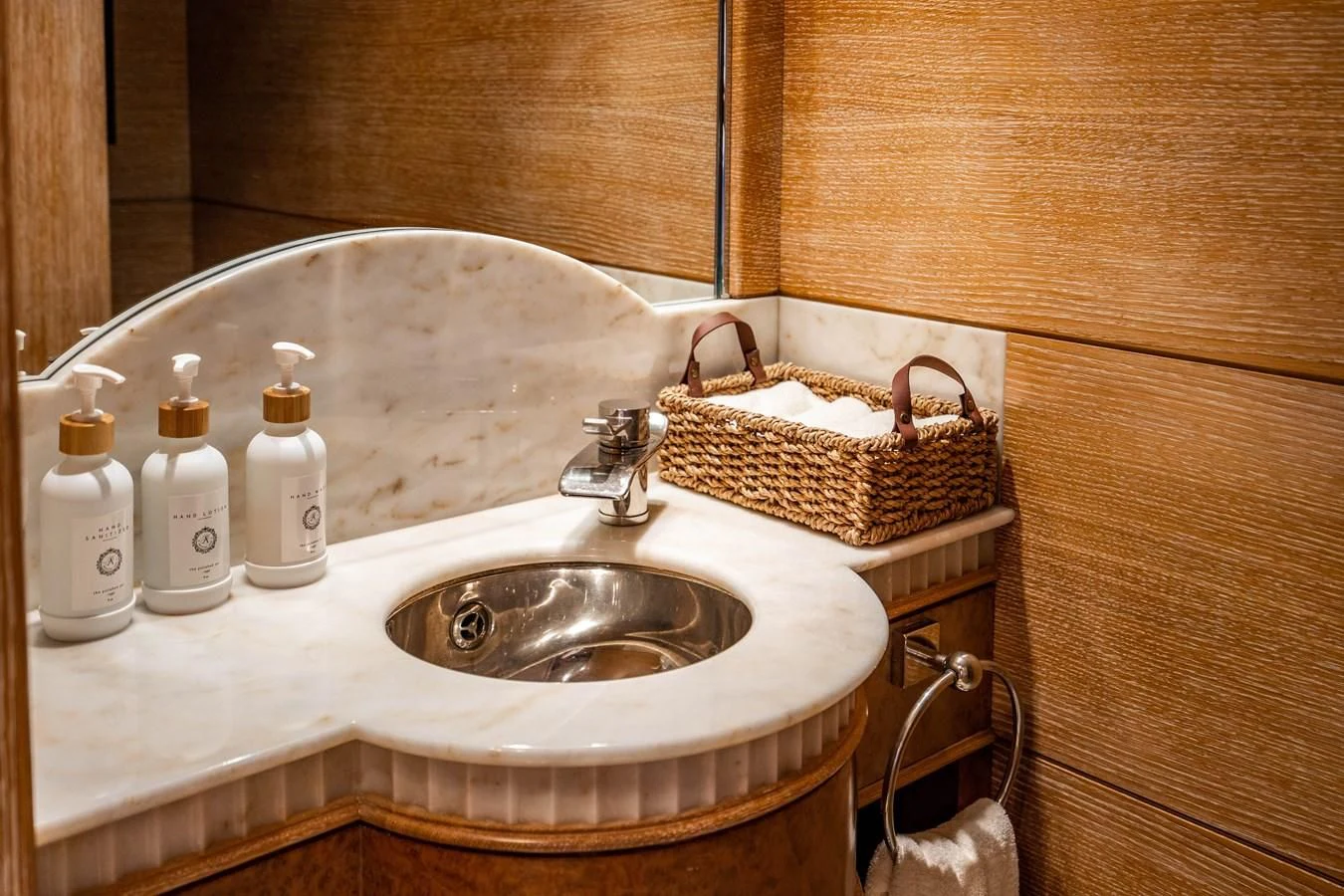 a bathroom sink with a basket and toiletries aboard ARTEMISEA Yacht for Sale